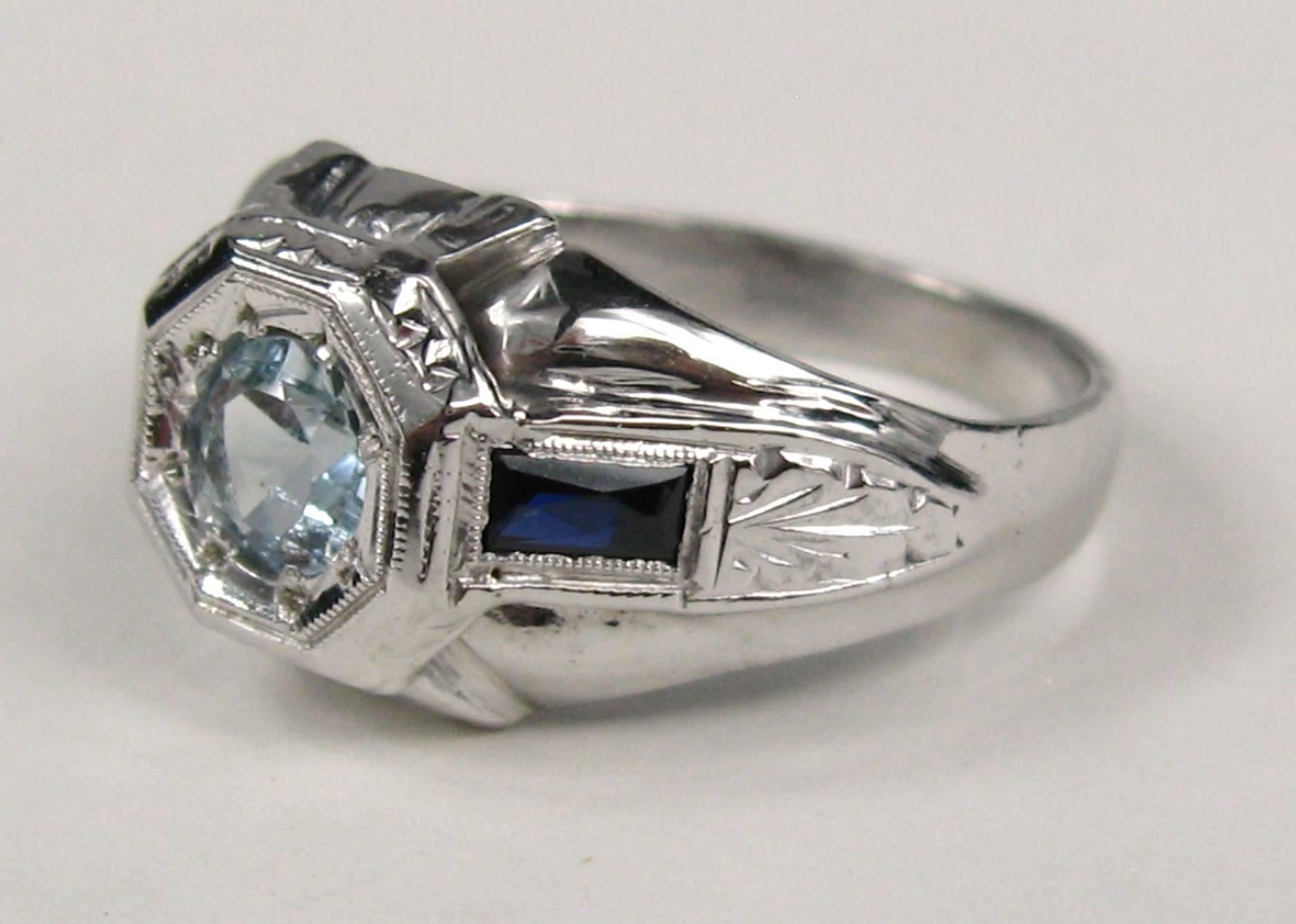 Early Art Deco White 18k Gold Ring with center Aquamarine flanked with sapphires on each side.. Ring is a size 7 and can be sized by us or your jeweler. This is out of a massive collection of Contemporary designer clothing as well as Hopi, Zuni,