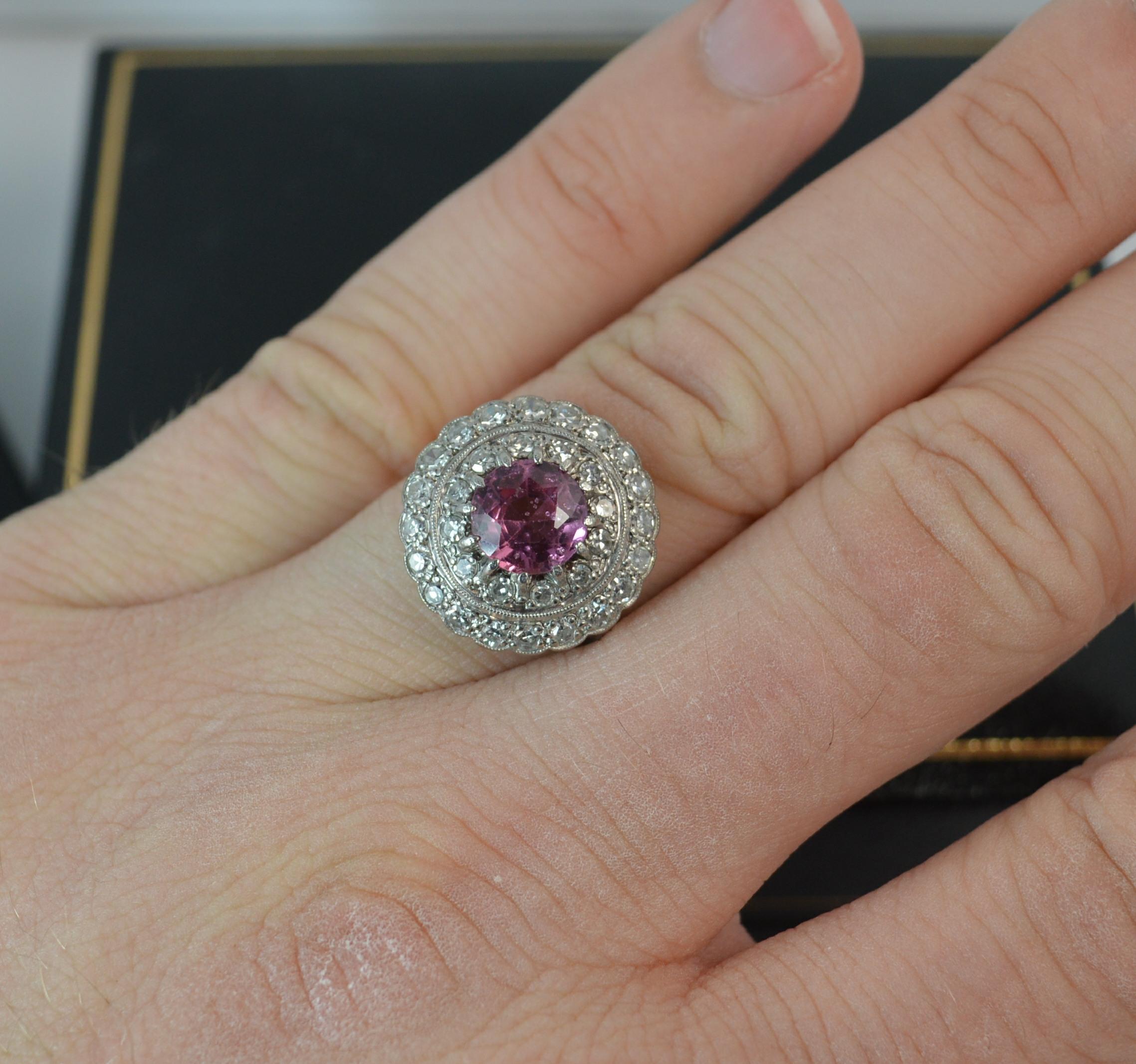 A stunning vintage cluster cocktail ring.
SIZE ; L 1/2 UK, 6 US
Solid 18 carat yellow gold shank with platinum head setting.

Designed with a round cut pink spinel stone to centre, 7mm diameter. Surrounding are two rows of natural round either cut