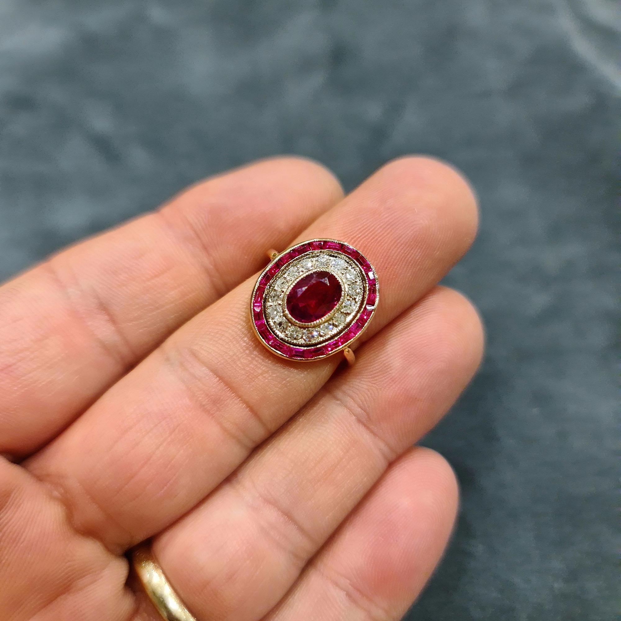 A beautiful, fine quality oval cluster ring. A central oval brilliant-cut ruby, in a bezel setting of platinum, surrounded by 15 single-cut diamonds and haloed by a channel of calibré-cut rubies, in 18-carat rose gold. Polish 18-carat rose gold