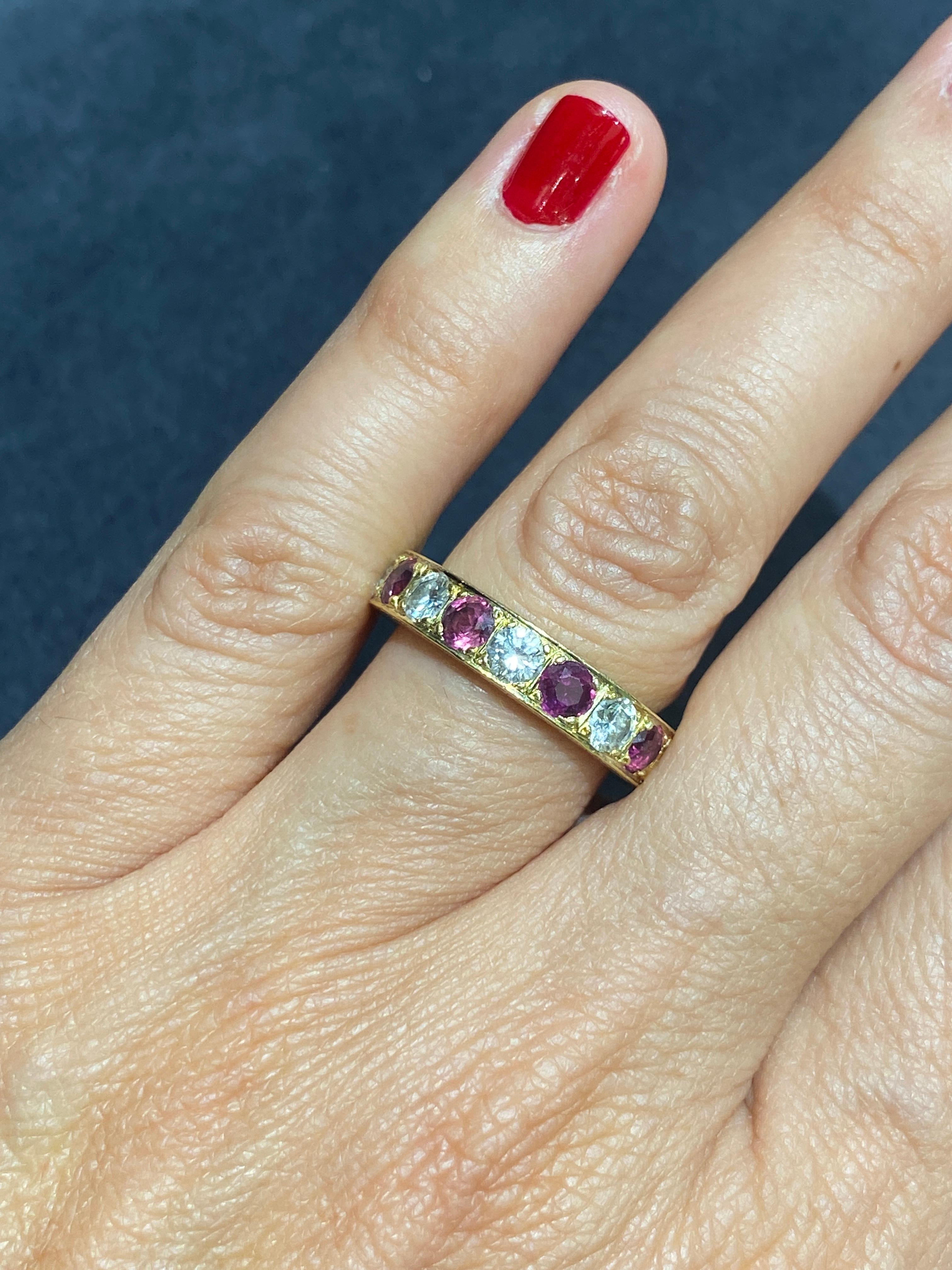This elegant 1920s engagement ring is made of 18k gold. It has approximately 1.7 carats of old European cut diamonds and 1.7 carats of old European cut rubies. The sides of the ring are beautifully engraved and carry the maker's mark JWN.