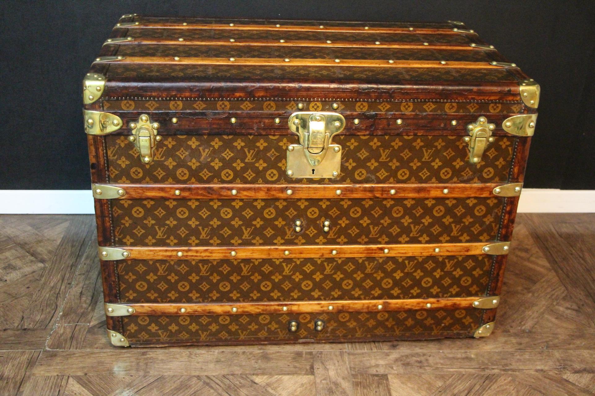 This superb Louis Vuitton steamer trunk features stenciled monogram canvas, deep chocolate color leather trim, LV stamped solid brass locks and studs as well as solid brass side handles and brass corners. It features a customized yellow and white
