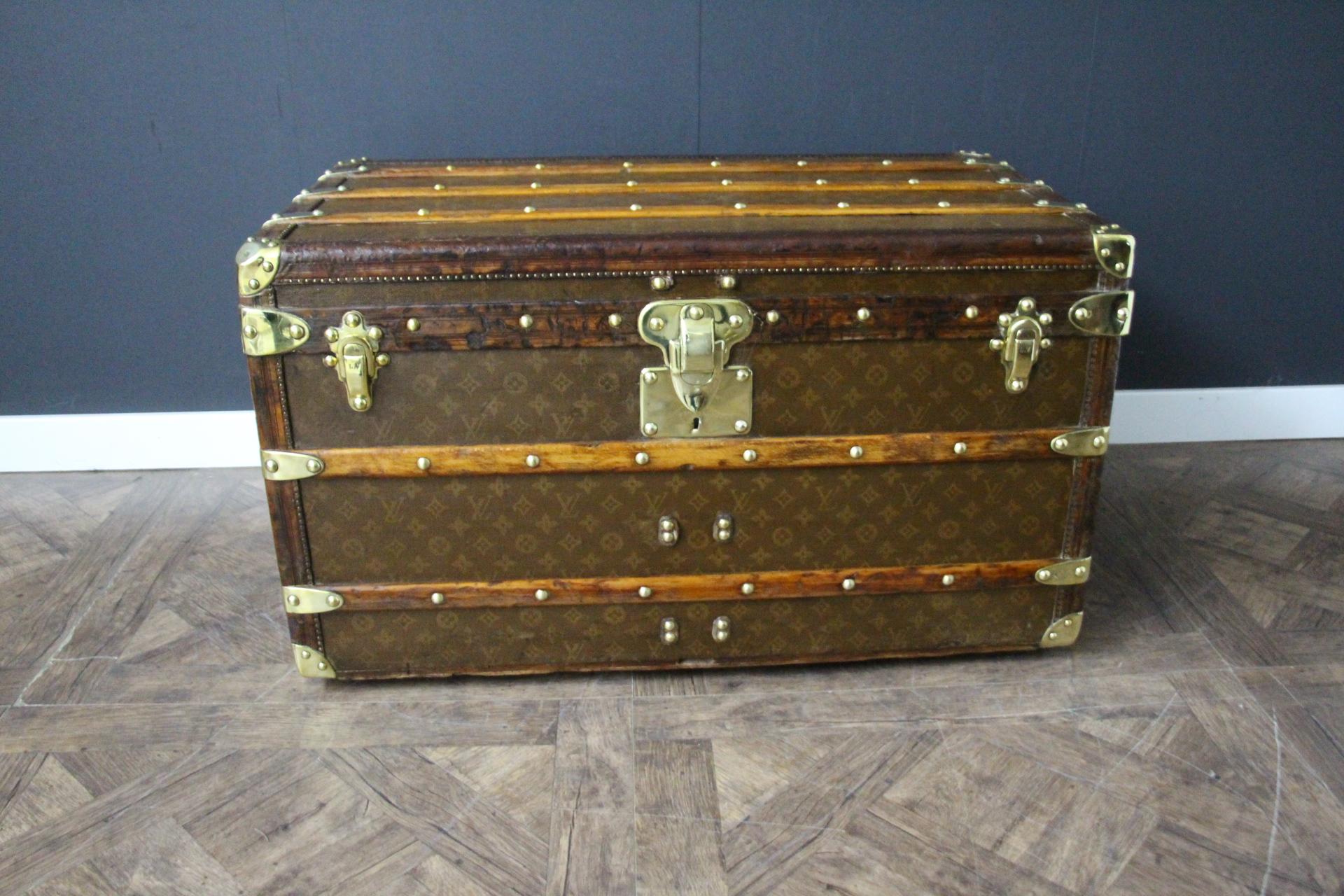 This superb Louis Vuitton steamer trunk features hand painted stenciled monogram canvas, deep chocolate color leather trim, Louis Vuitton stamped solid brass locks, clasps and studs as well as solid brass side handles and brass corners. It features