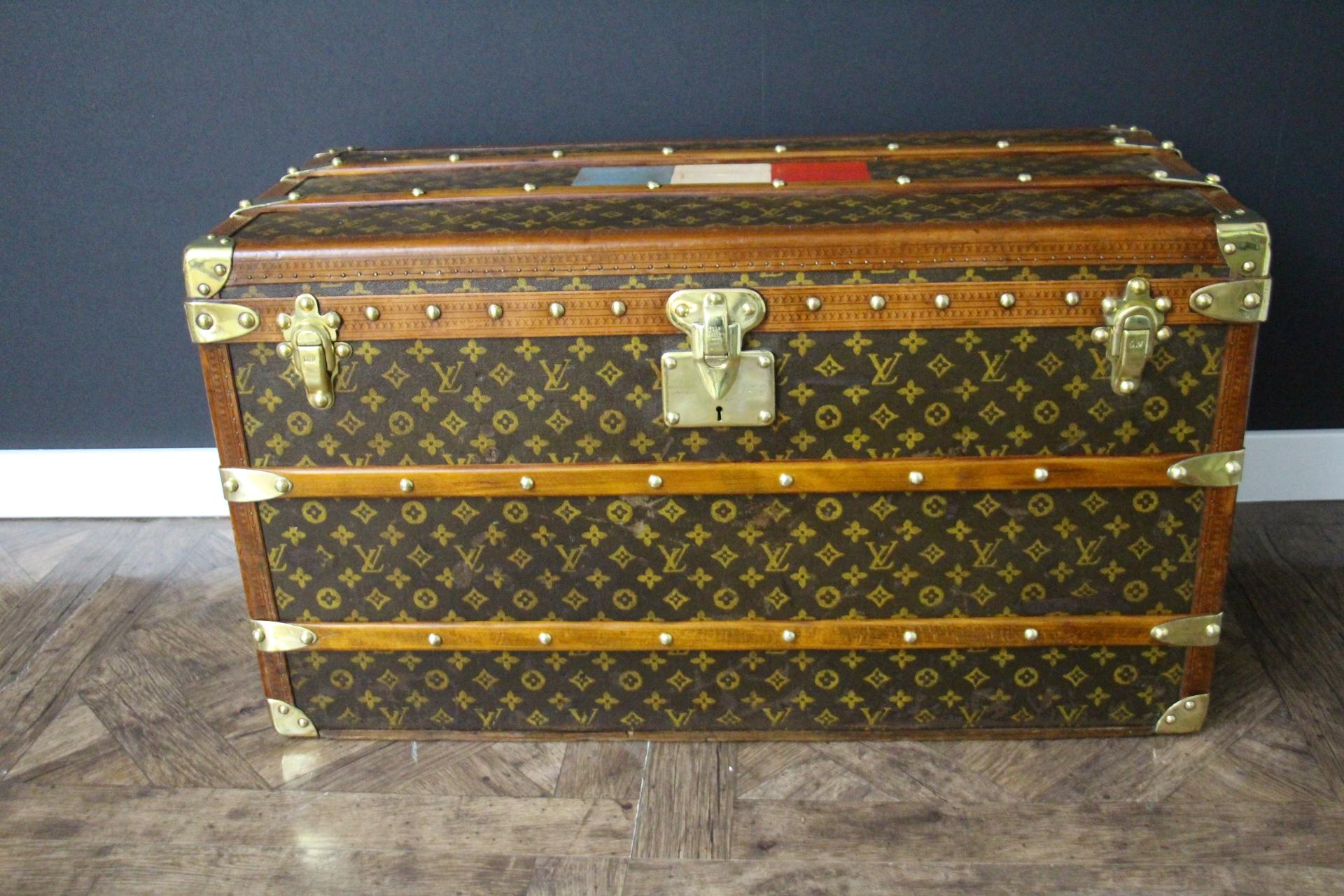 This magnificent Louis Vuitton steamer trunk features hand painted stenciled monogram canvas, golden honey color lozine trim, Louis Vuitton stamped solid brass locks, clasps and studs as well as marge leather side handles and brass corners. It