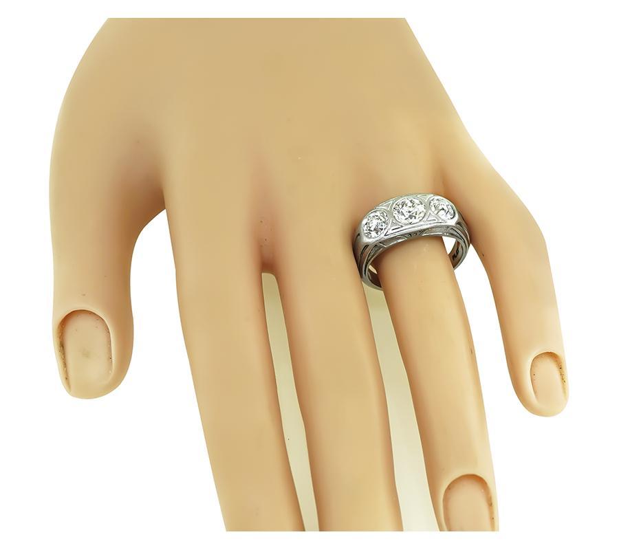 This is an elegant platinum men's ring from the 1920s. The ring is set with 3 sparkling old mine cut diamonds that weigh approximately 2.50ct. The color of these diamonds is G-J with VS2 clarity. The top of the ring measures 9mm by 19.5mm. The ring