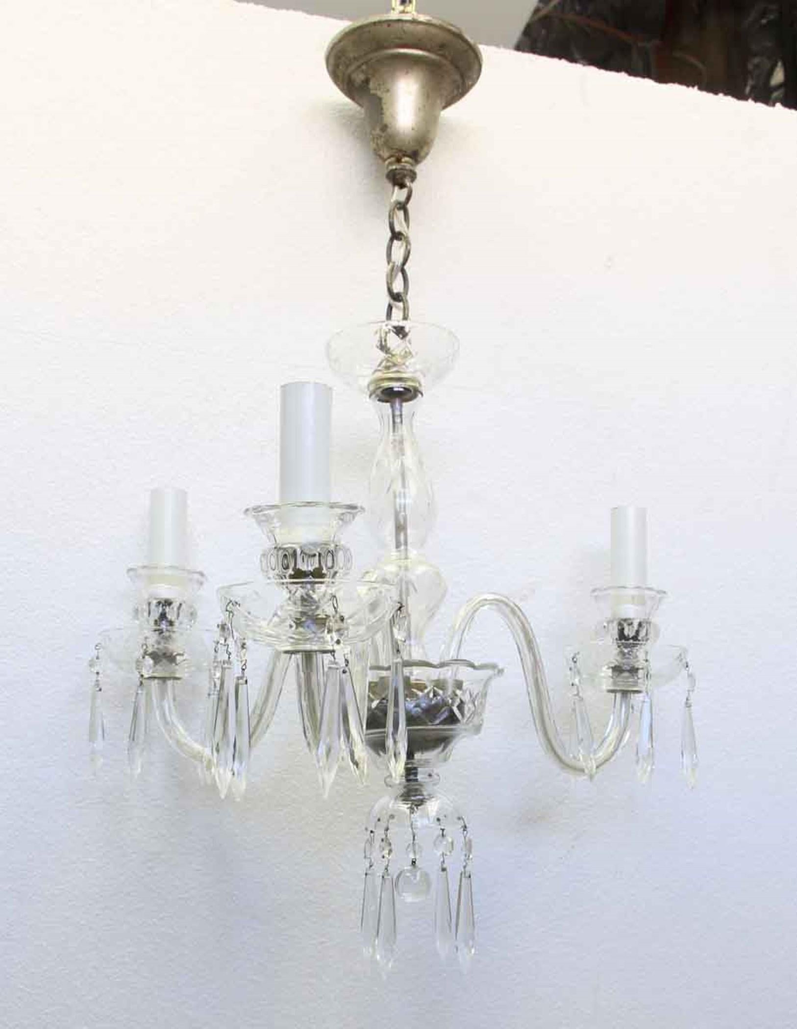 Petite crystal and glass three-arm chandelier with a teardrop and ball finial. Distressed silver over the brass on the canopy. Perfect for a powder room or small feminine bedroom. Price includes wiring. 1-2 weeks to process. This can be seen at our