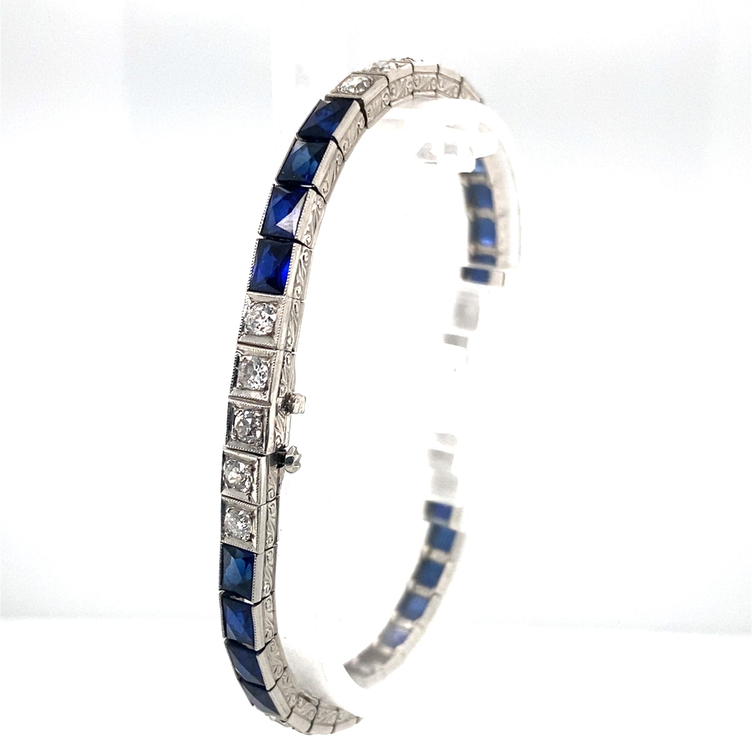 Item Details: 
Metal: Platinum 
Weight: 20.5g
Measurements: 7 inches long 

Diamond Details:
Cut: Old European Cut 
Carat: 3 carat total weight 
Color: H
Clarity: VS-SI 

Blue Glass Details:
Cut: French cut 
Color: Blue 

Item Features:
This