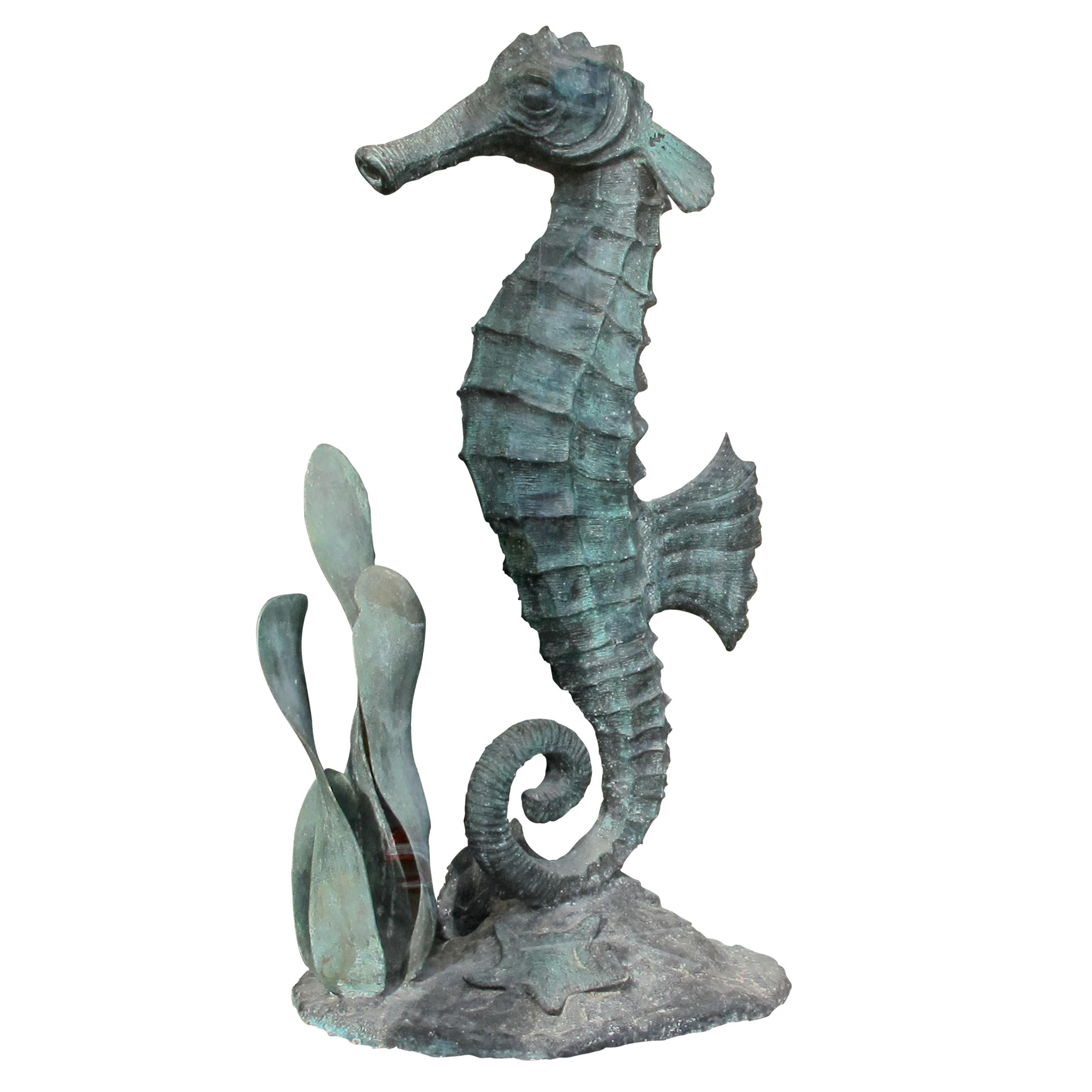 Unique and elegant French highly decorative large bronze sculpture from the Art Deco period. The bronze sculpture represents a scene of a hippocampus standing upright on a sea bed decorated with tall seaweed, two fish and starfish. The sculpture has
