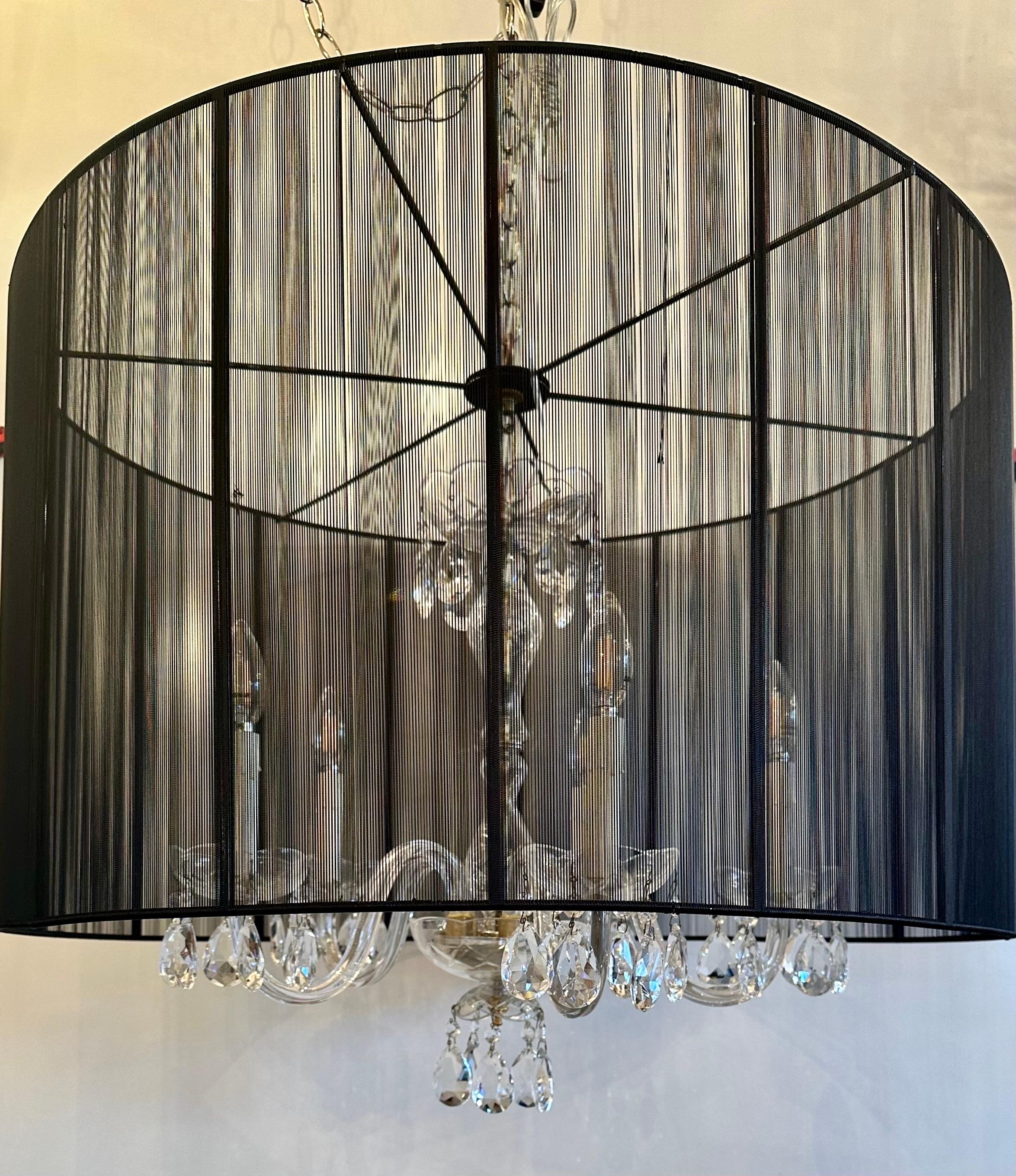 Adding this black modern silk shade to this antique crystal chandelier brings it to life in a modern way. A little mix of old with the new!