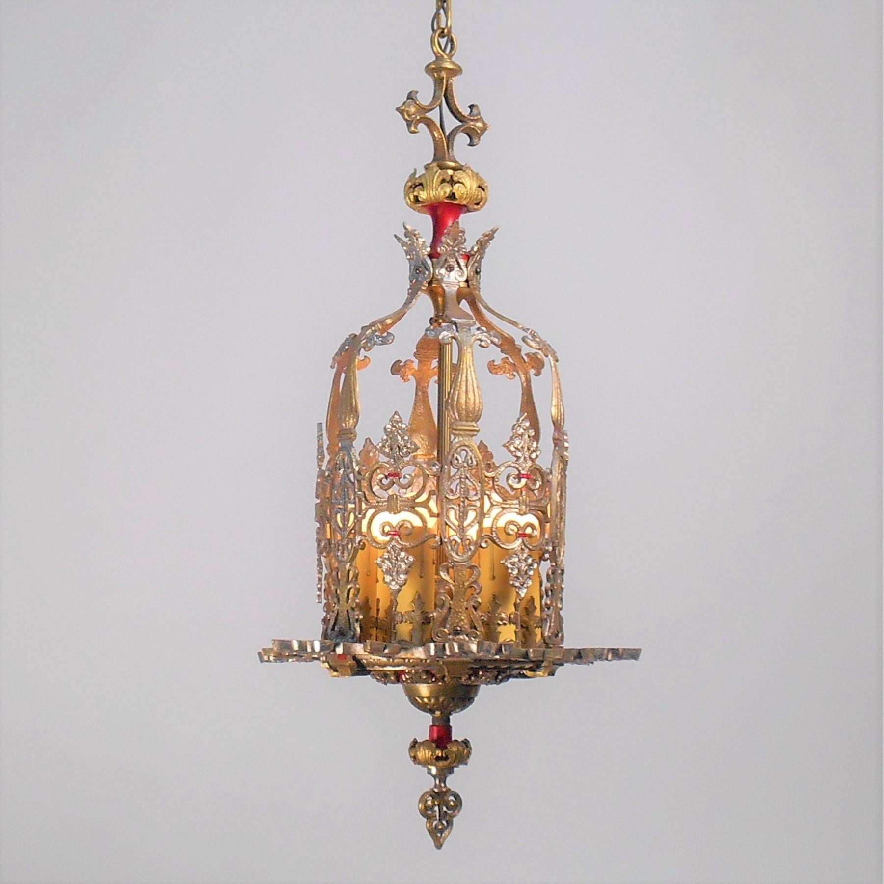 Incredible example of a meticulously restored 1920's decorative pendant lantern. Reticulated cast brass featuring red, silver and gold accents. Made by the Max Schaffer Co. Circa 1920's

Size: 14