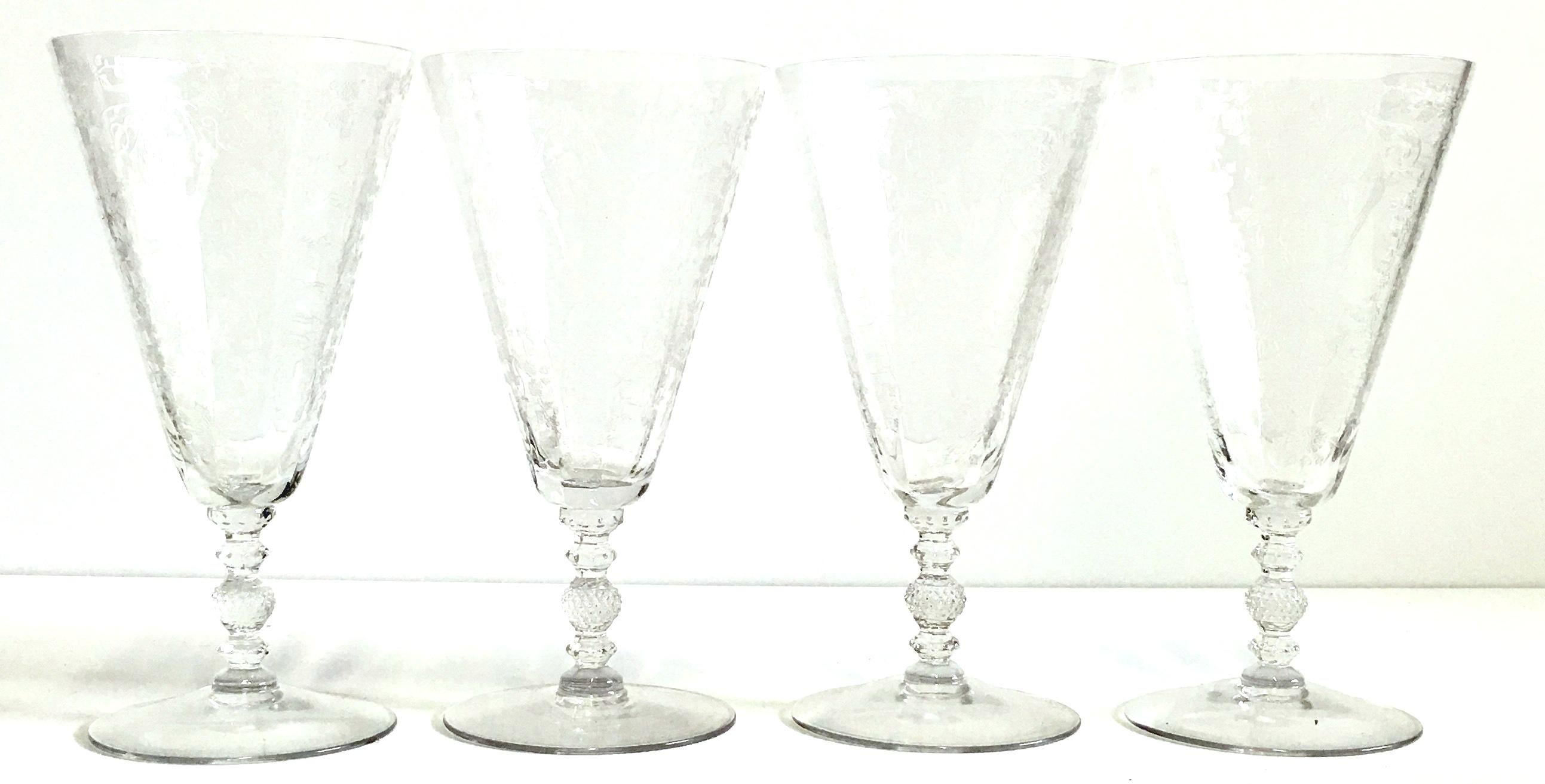 1920s Art Nouveau etched crystal cut stem glasses, set of four pieces. Features a delicate and heavy floral vine pattern with a lovely and substantial optic cut stem and simple clear foot.



   