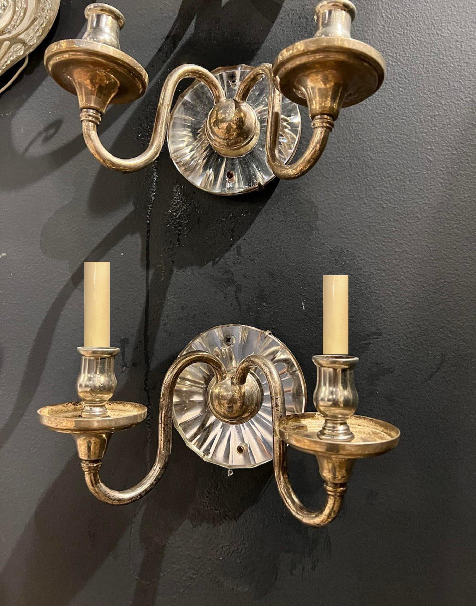A pair of circa 1920's  American silver plated sconces with mirror backplate and two lights
