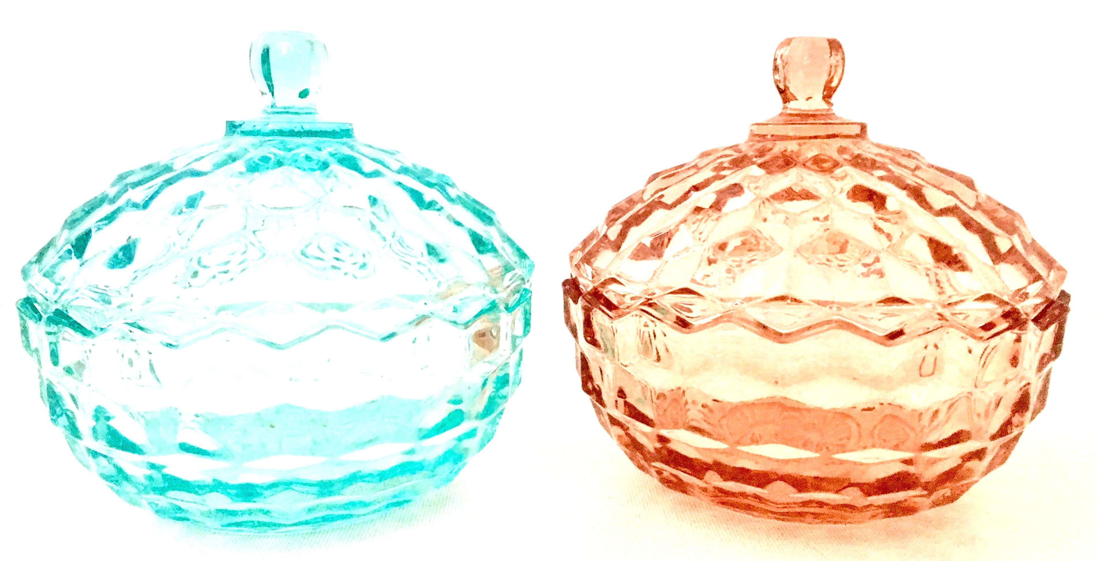 1920'S American diamond cut depression era glass lidded jars, set of two. Set includes one teal blue and one pink lidded jar.