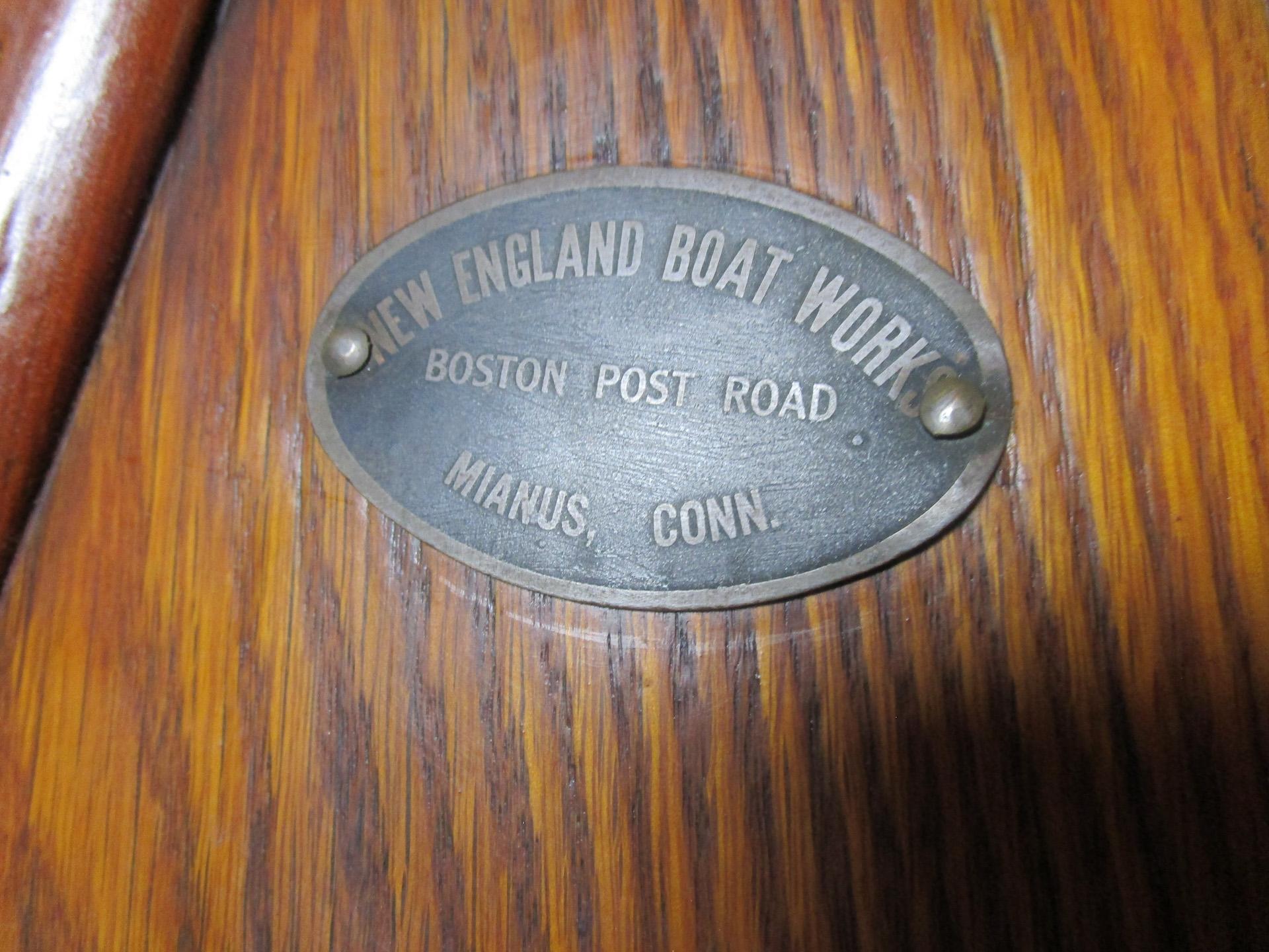 American oak and cedar canoe with a brass plaque that reads: New England Boat Works Boston Post Road Niamus Conn. The history of this yard is one of extensive construction of International Star Class Yachts and some small craft boats. Established in