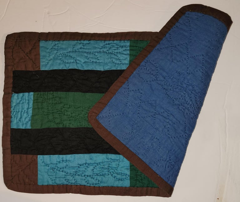 Early 20th C Amish doll quilt of bars & blocks in very fine condition. This doll quilt has very fine tight quilting. Wonderful graphic colors and fine condition from Ohio. Hand bound & quilted. This quilt is published in '
