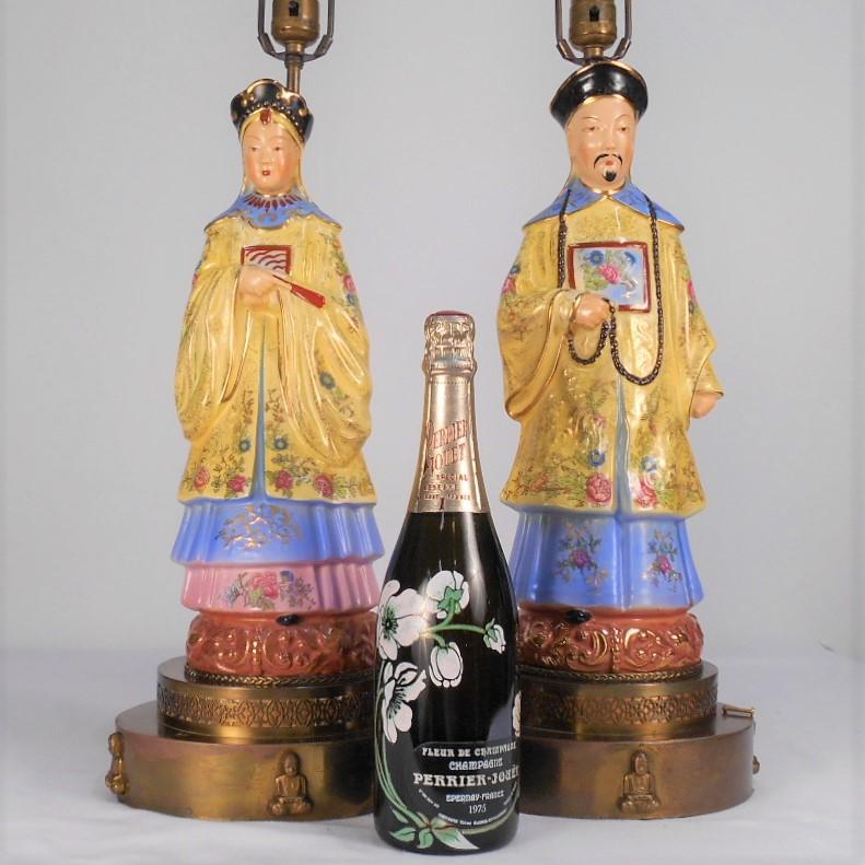 Porcelain table lamps in the likeness of ancestor portraits. Each featured on custom handmade brass bases with applied dimensional brass buddha figures. These porcelain figures were designed to be lamps for the American market. The male ancestor is