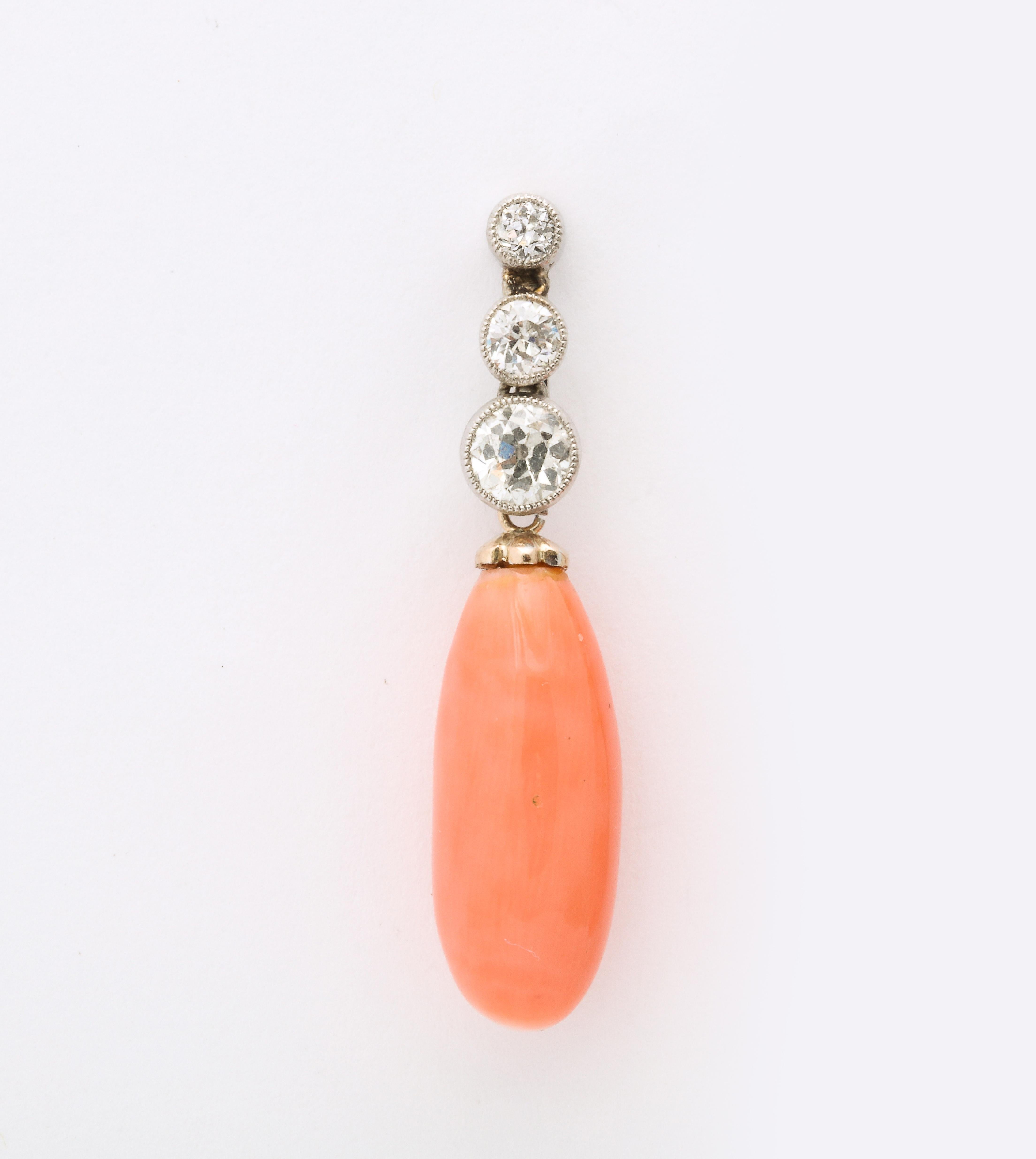 One Ladies Pair Of  Circa 1920's Platinum And 18kt Gold Drop Earrings Designed With Two Angel Skin Coral Drops Measuring Approximately 18MM Each. Top Of Earrings Embellished With Six Old Cut Diamonds Beautifully Set Within A Milgrain Workmanship.