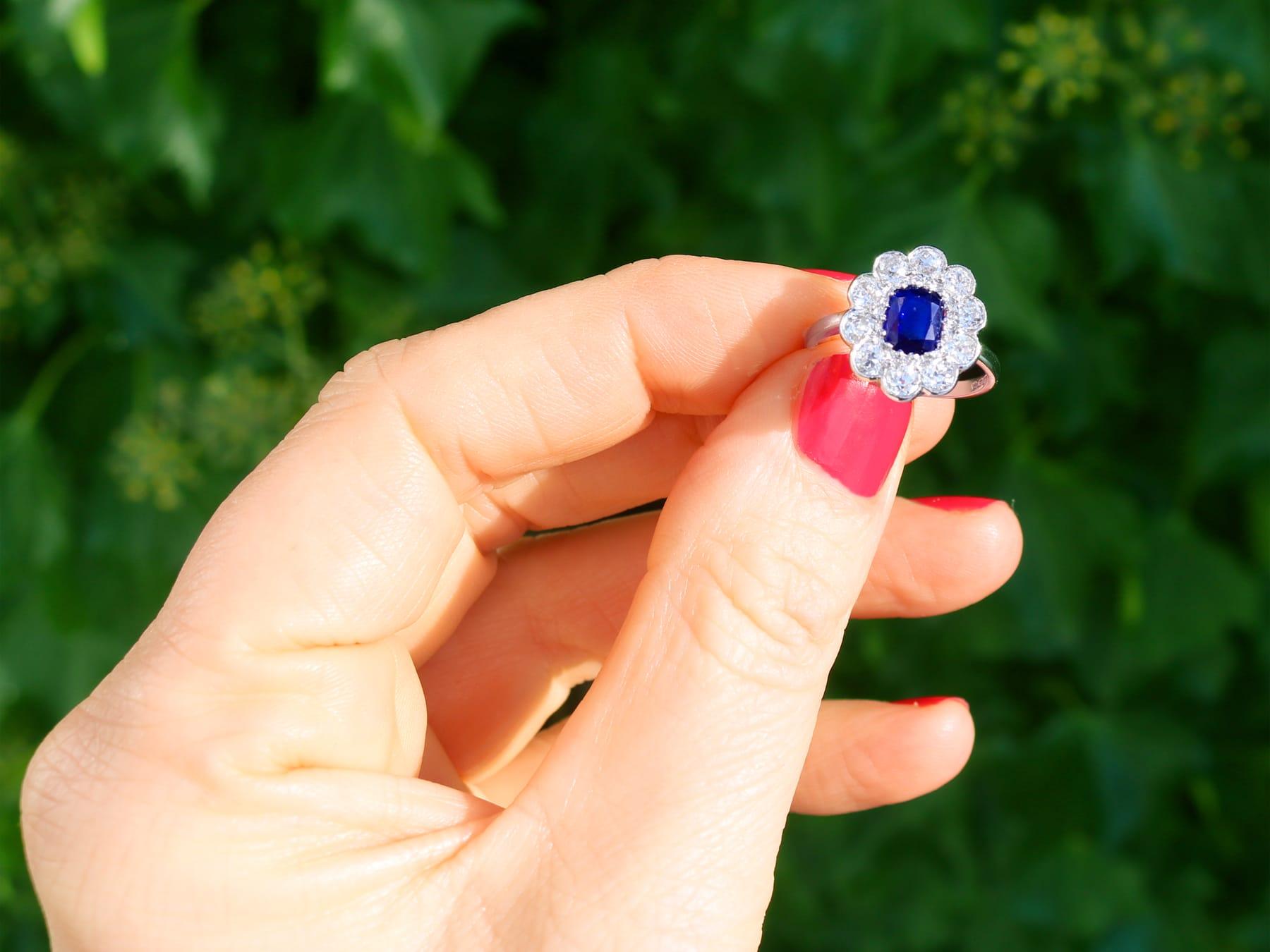 A fine and impressive antique 1920s 1.07 carat sapphire and 1.54 carat diamond, platinum cluster style dress ring; part of our diverse antique jewelry and estate jewelry collections.

This fine and impressive antique sapphire and diamond ring has