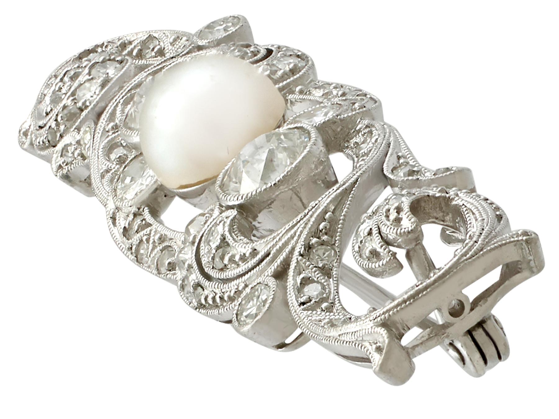 A stunning antique 1920s 2.30 carat diamond and pearl, 14 karat white gold and platinum set brooch; part of our diverse antique jewelry and estate jewelry collections.

This stunning, fine and impressive antique pearl and diamond brooch has been