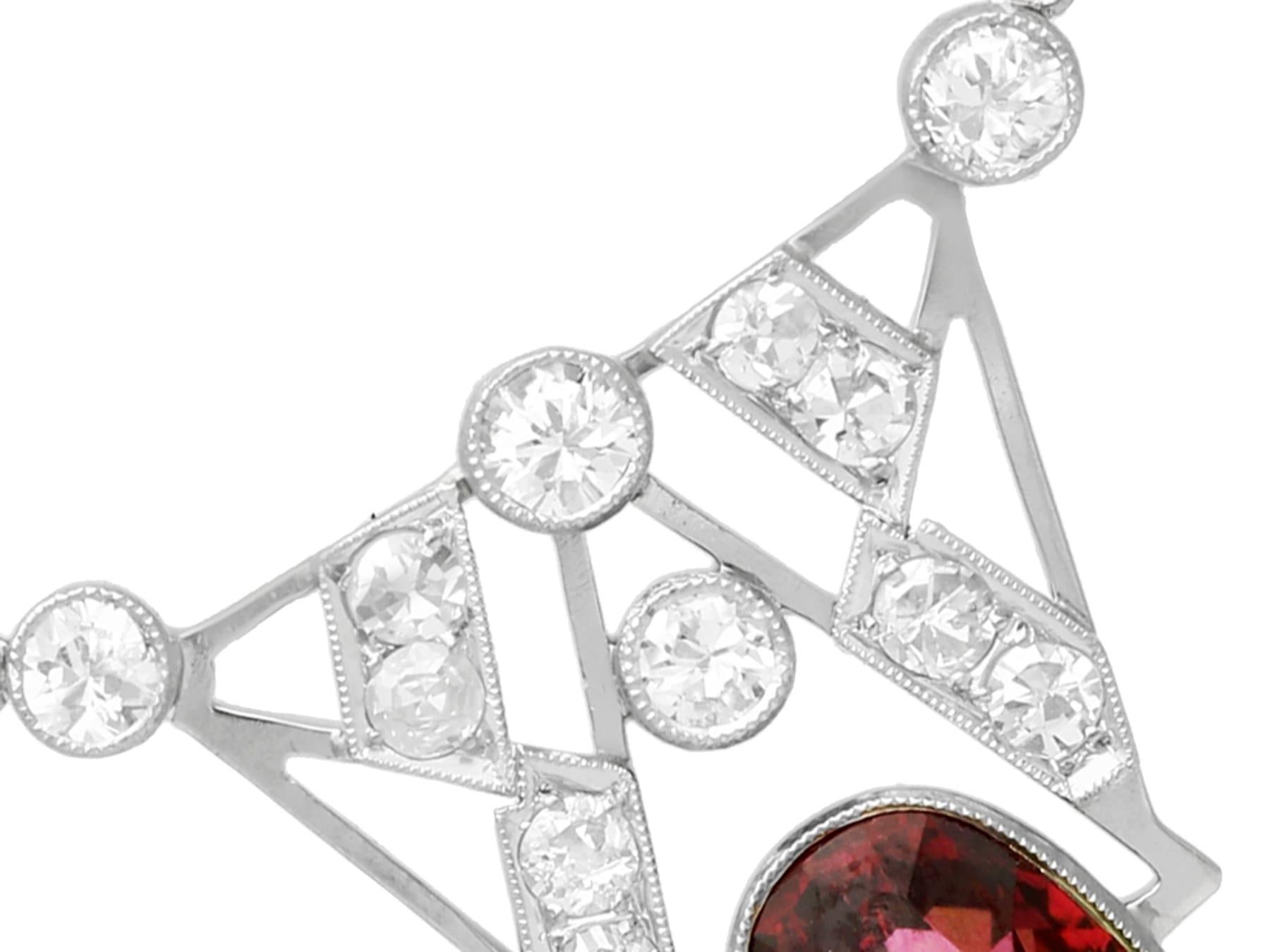 A stunning, fine and impressive antique 4.32 carat garnet and 1.08 carat diamond, 18 karat white gold Art Deco pendant; part of our diverse antique jewelry and estate jewelry collections.

This stunning antique Art Deco necklace has been crafted in