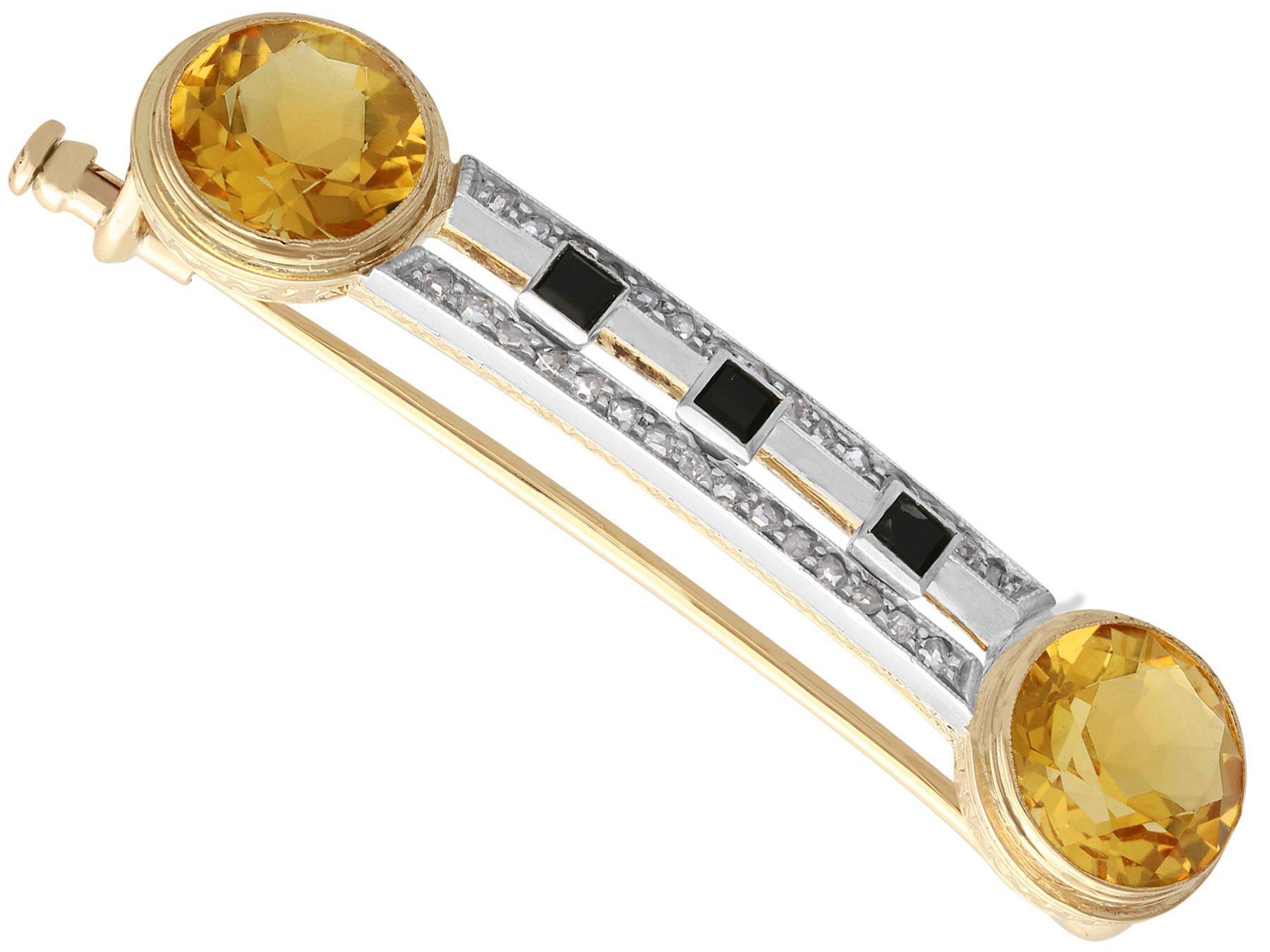  A fine and impressive antique 6.69 carat citrine, 0.28 diamond and onyx, 14 karat yellow gold brooch; part of our antique jewelry/estate jewelry collections.

This fine and impressive antique brooch has been crafted in 14k yellow gold with a silver