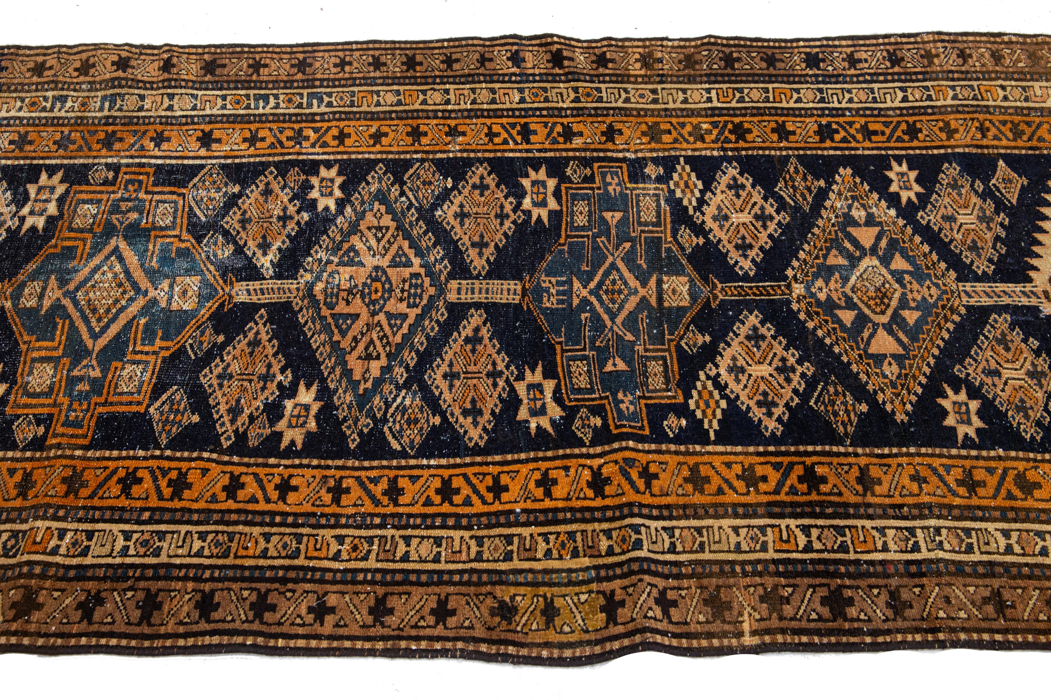 Persian 1920s Antique Blue Heriz Wool Runner Handmade with Tribal Motif For Sale