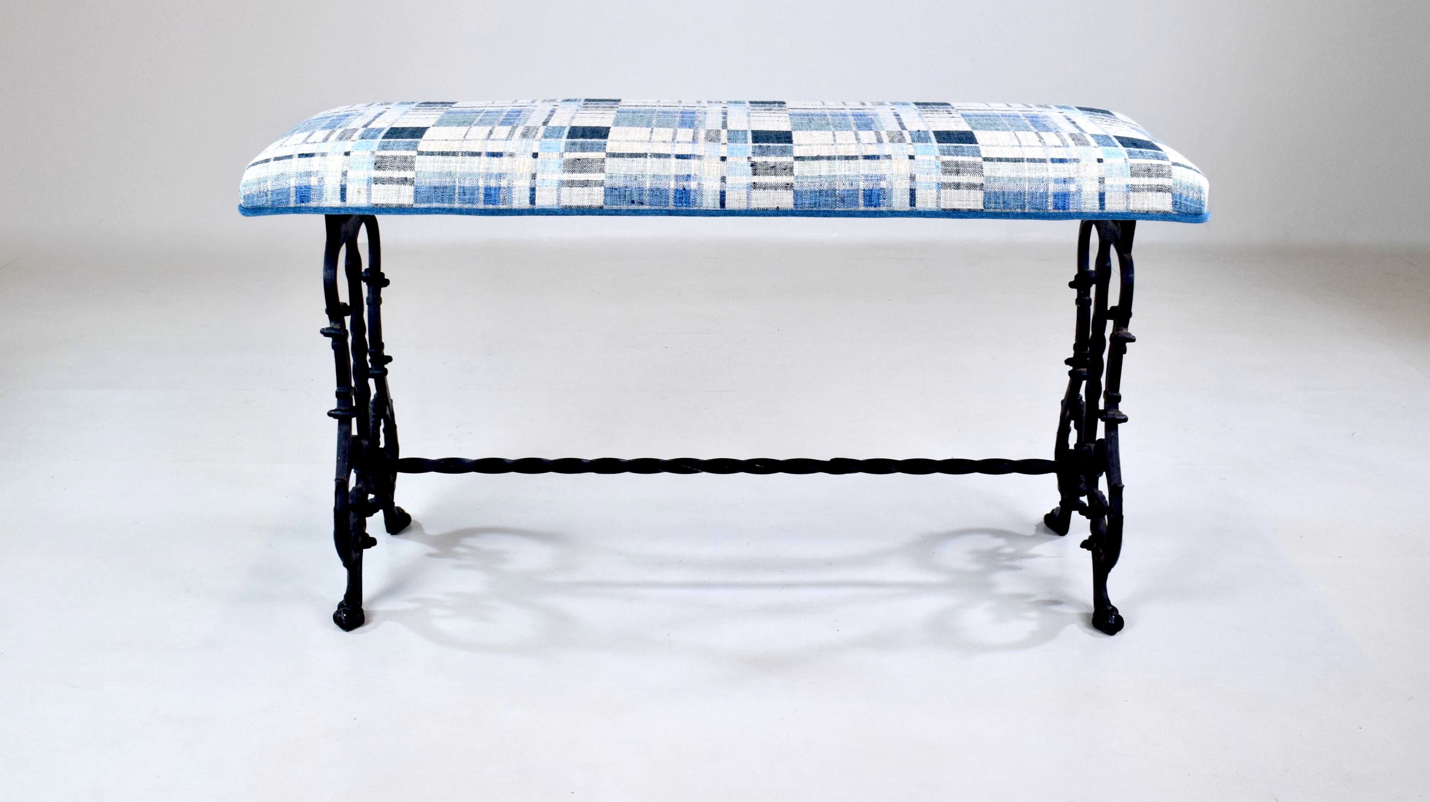 A sweet antique Cast Iron bench in new blue & white woven upholstery. Versatile, solid mid size ready for use.