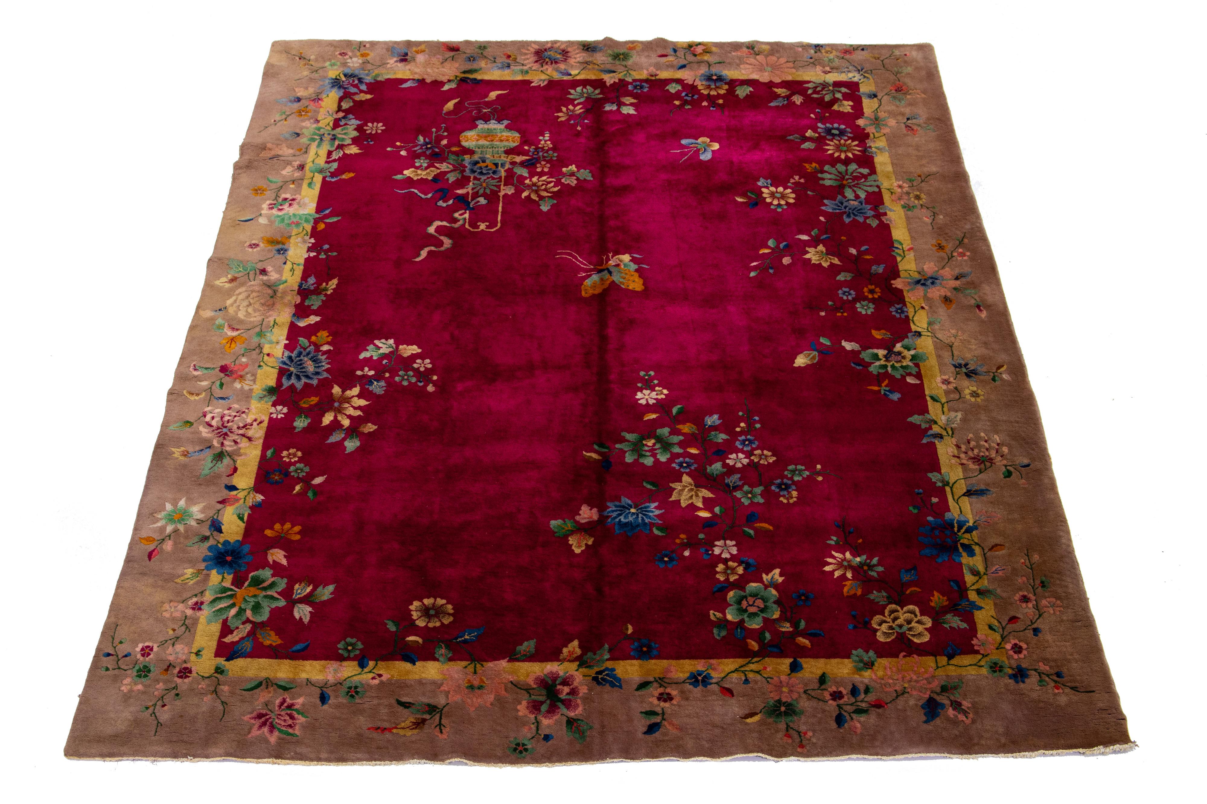 Beautiful 1920s antique Chinese Art Deco hand-knotted wool rug with a red field brown frame in a classic Chinese floral design.


This rug measures 8' 10