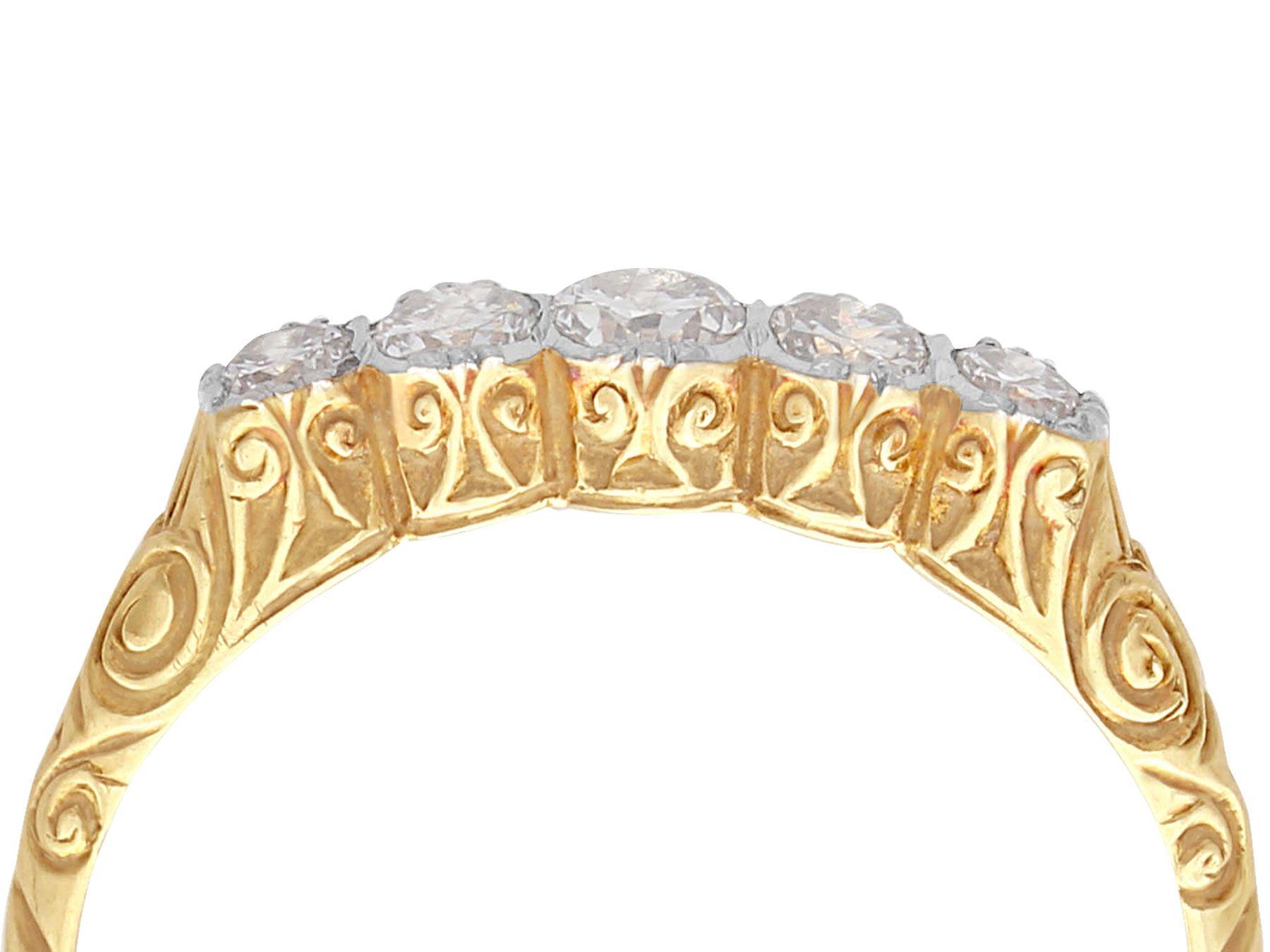 A fine and impressive antique 0.42 carat diamond and 14 karat yellow gold, 14 karat white gold set five stone ring; part of our antique jewelry and estate jewelry collections.

This impressive 1920s band ring has been crafted in 14k yellow gold with