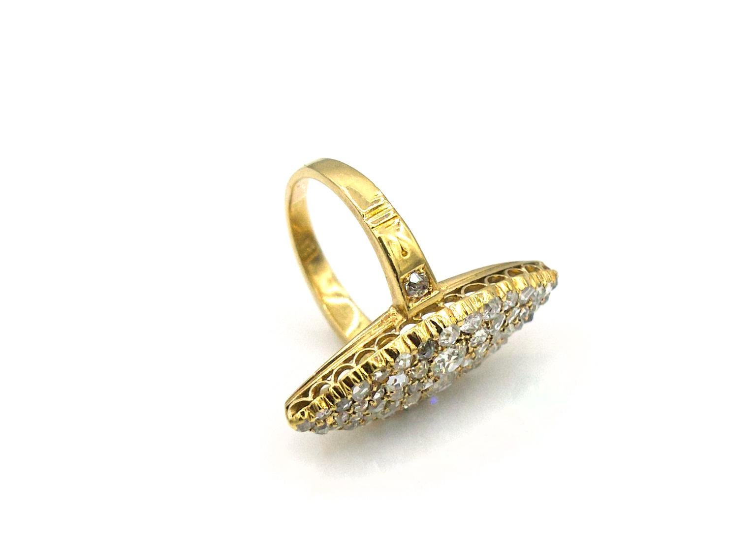 This statement antique ring from the 1920s features a marquise shape that is made of 18K yellow gold and a mix of shiny rose-cut and old miner's diamonds. The diamonds weigh in at approximately 3 Carats total. An extra special component is the