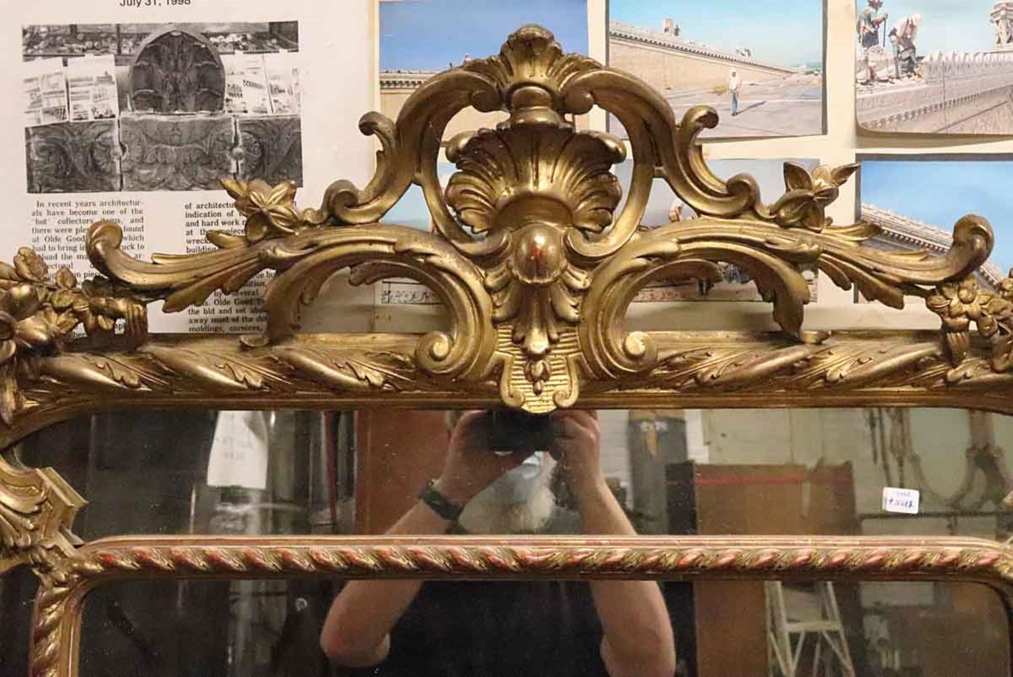 1920s decorative French gilded mirror with floral detailing. Minor damages, please see photos. This can be viewed at one of our New York City locations. Please inquire for the exact address.