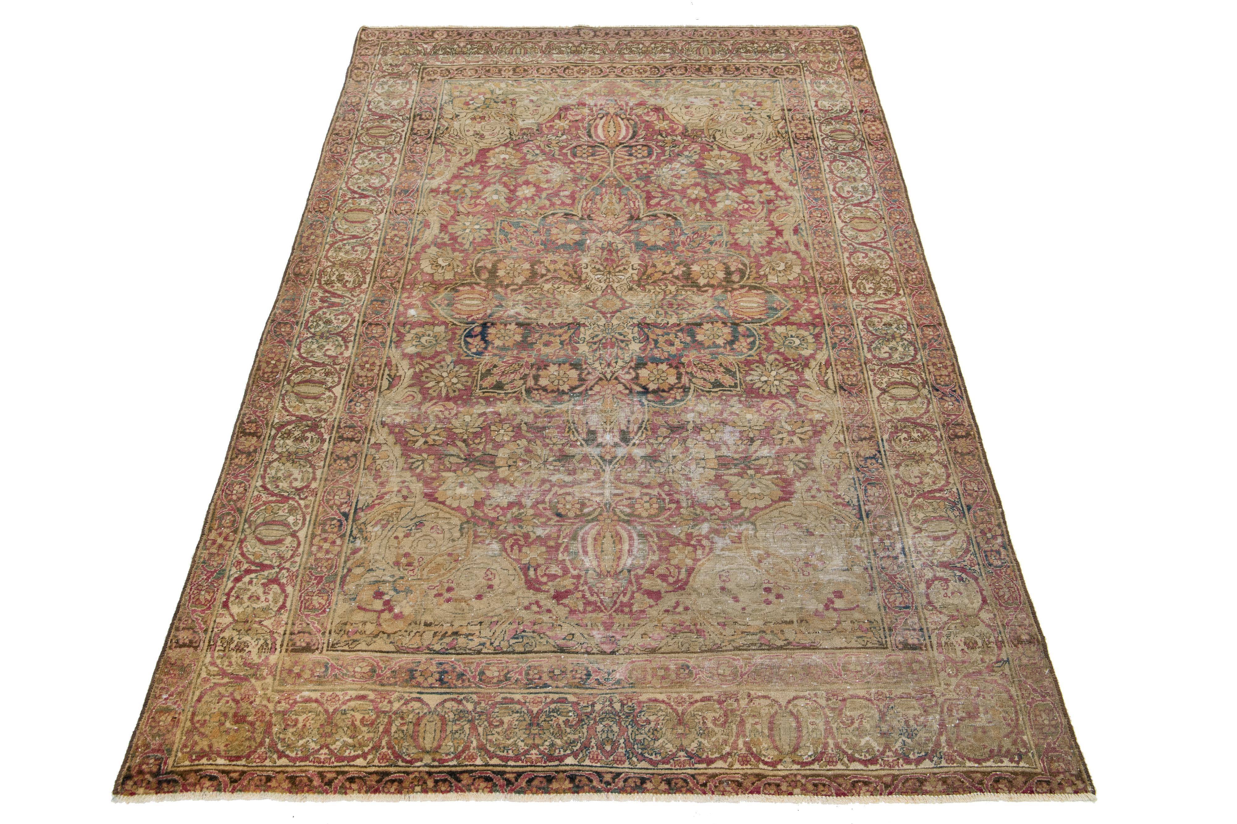 This Antique piece is a hand-knotted Persian Kerman rug with a texture and red field—Highlighted with red and blue accents in an all-over medallion floral pattern.

This rug measures 4' x 6'9