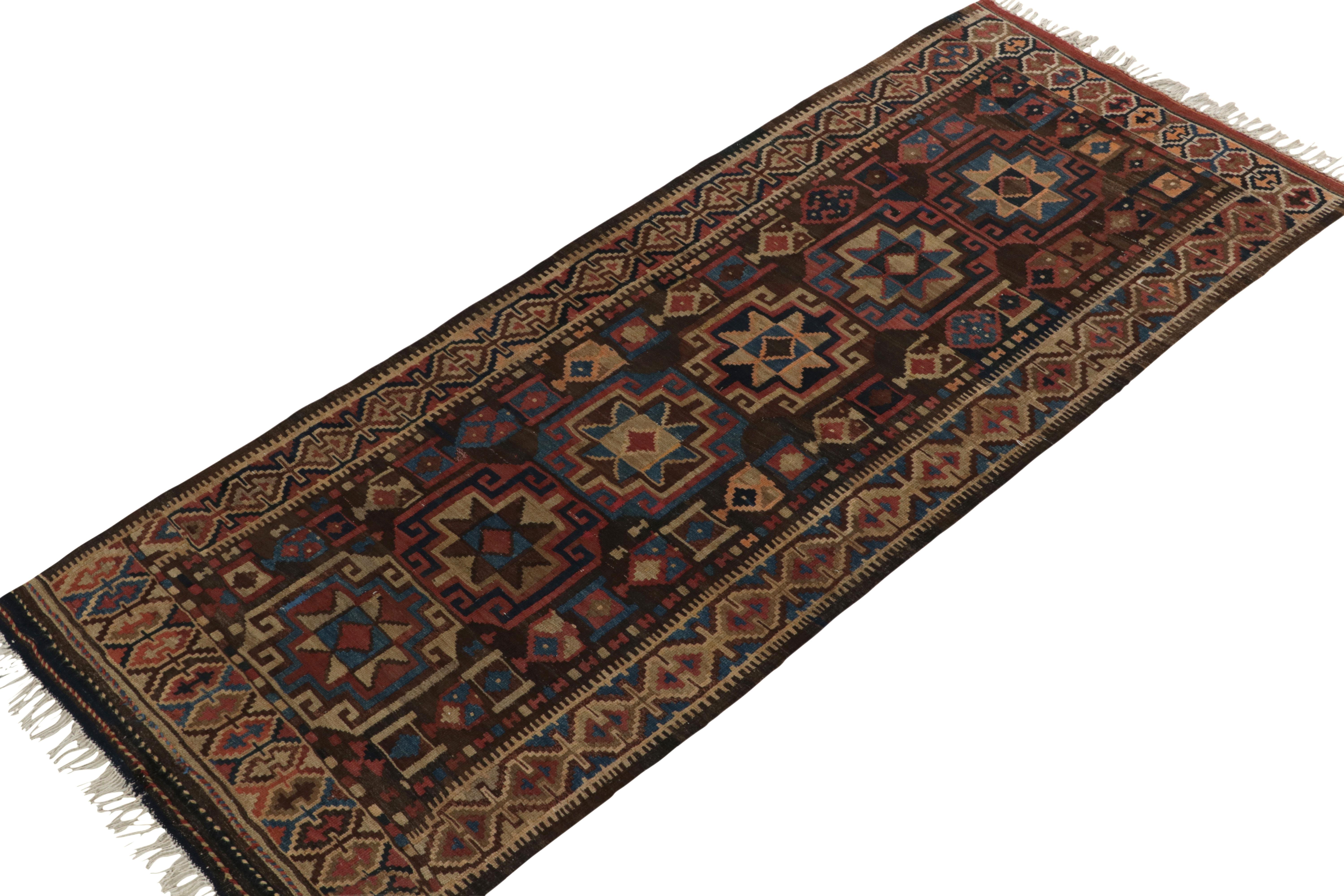 Handwoven in wool circa 1920-1930, this 4×9 antique Caucasian Kilim runner rug is believed to be of Kurdish provenance.

On the Design:

A rich chocolate brown underscores beige, aegean blue and raspberry red tones among the palette of traditional