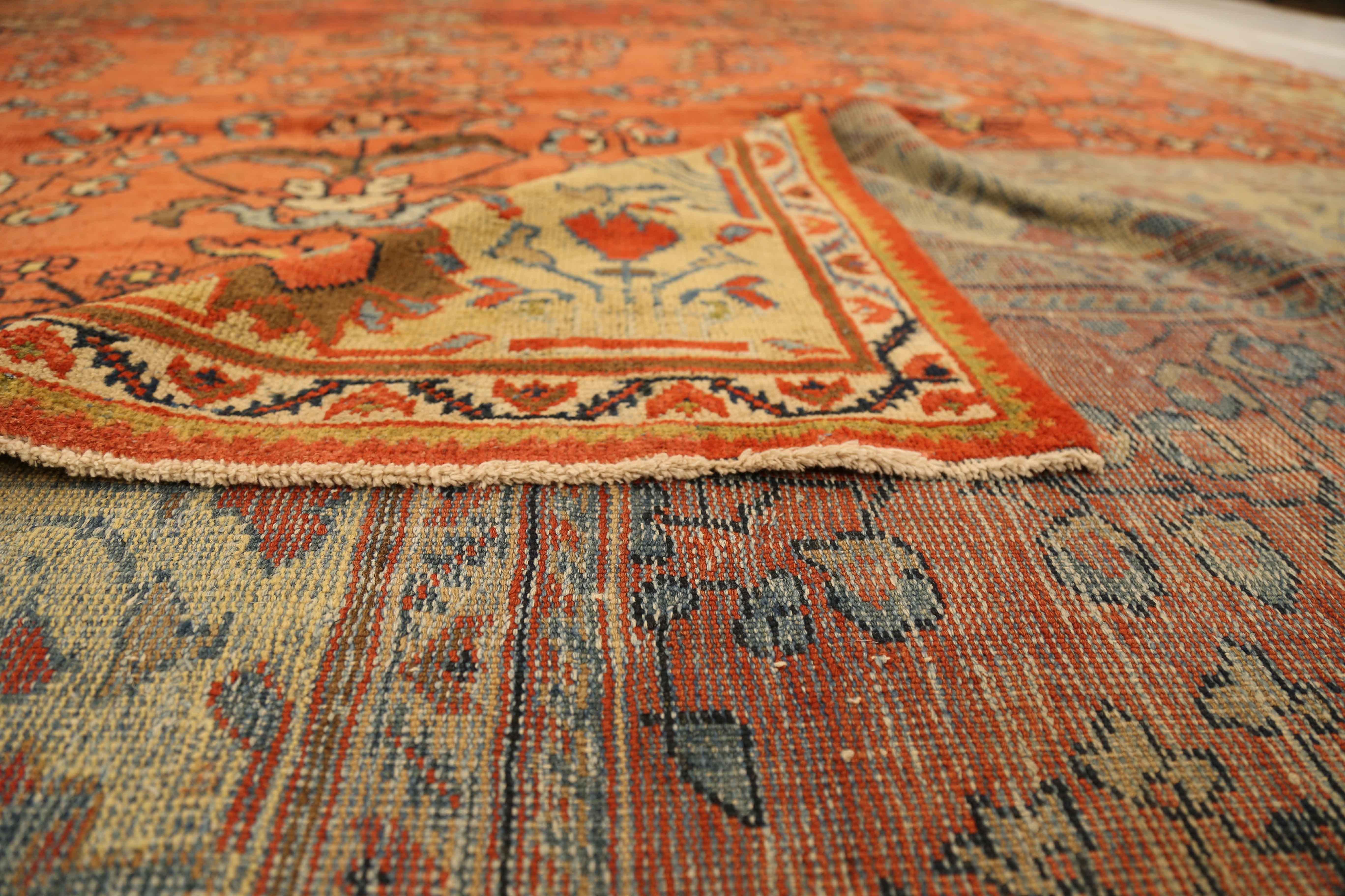 It was made in the 1940s using fine wool and all-natural dyes. It’s an antique Persian rug hand knotted using floral design patterns, a specialty of master weavers in the ancient village of Mahal, Persia. It has a vibrant color palette of red,