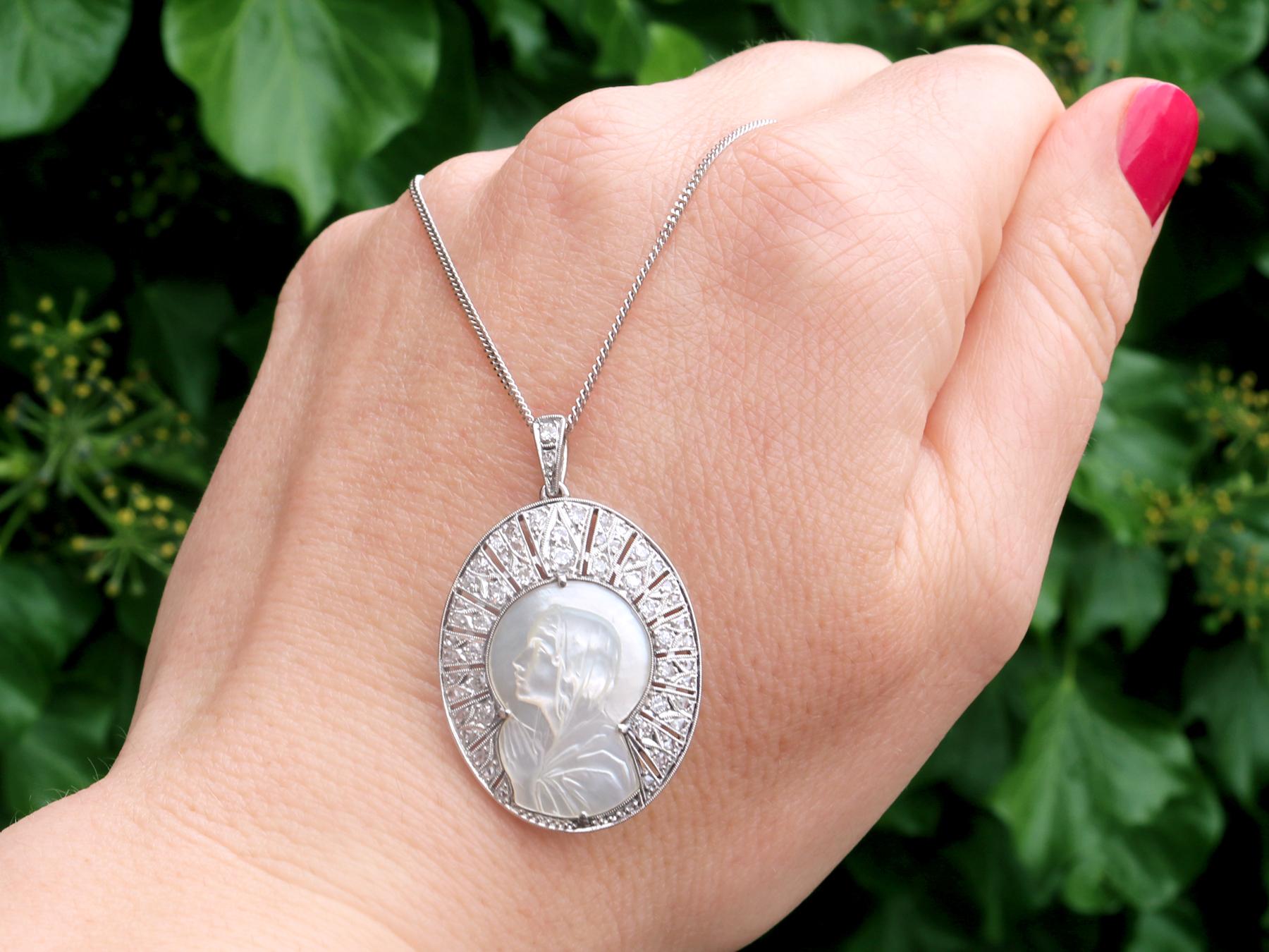 A stunning, fine and impressive antique 1920s mother of pearl and 0.45 carat diamond, platinum pendant; part of our diverse antique jewelry and estate jewelry collections.

This stunning, fine and impressive antique pendant has been crafted in