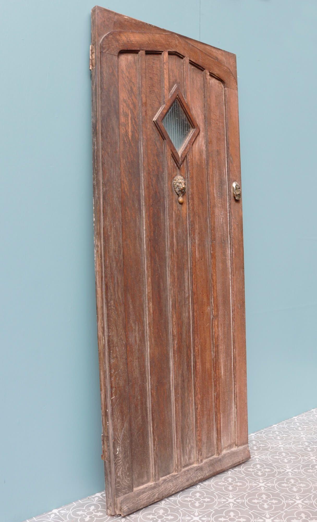 Made in the 1920s, this antique oak front door is a handsome entrance to a period cottage. Reclaimed from a property in the heart of England, it is strong and sturdy and comes with a key. It is an original 1920s front door made from vertical oak