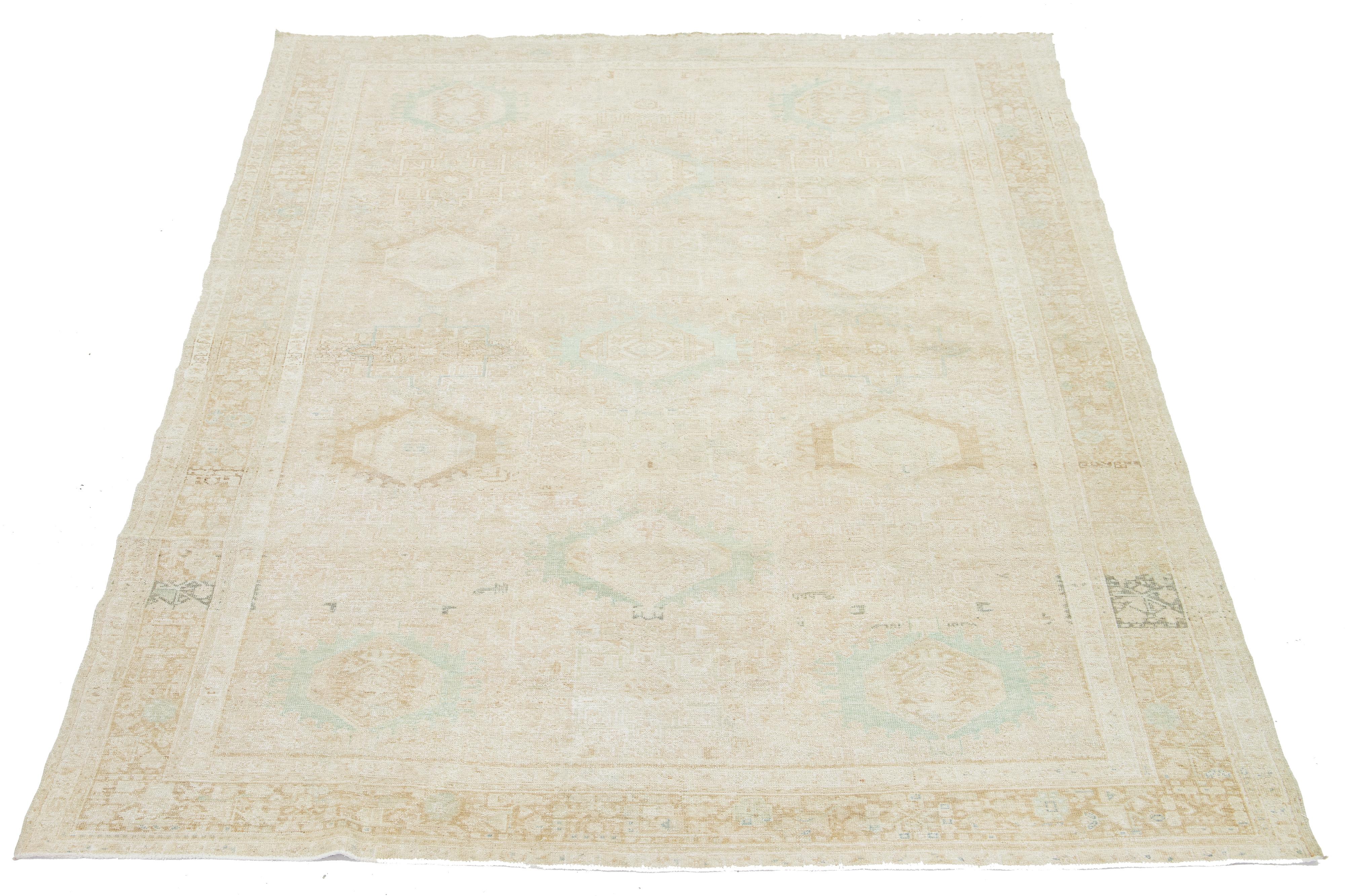 This exquisite antique Persian Heriz wool rug showcases a captivating green design that beautifully enhances a luxurious deep beige background.

This rug measures 8' x 10'10