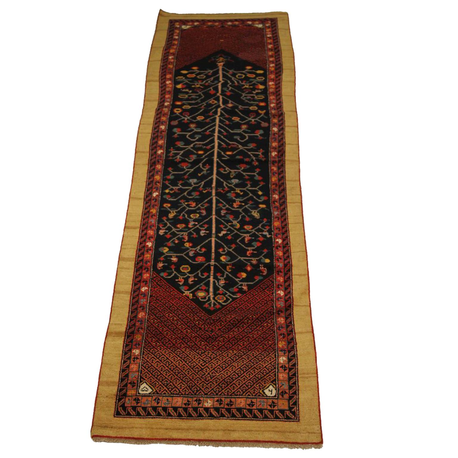 Antique Persian rug made of fine camel hair featuring ornate animal and geometric patterns which are traditional designs commonly used by weavers in Bakhtiari. It has a deep black, red, and ivory color palette that would look plush in modern and