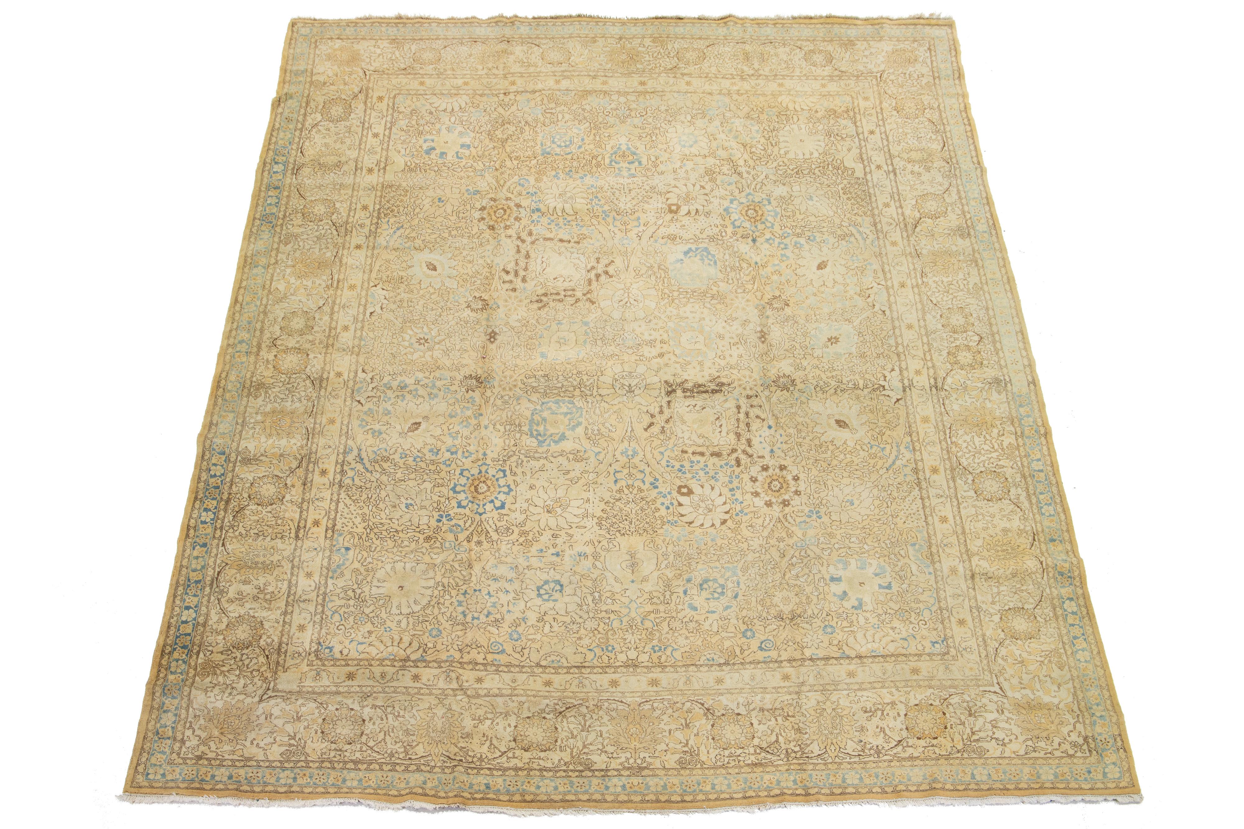 This antique Persian Tabriz rug from the 1920s features a beige field with a captivating floral pattern accented by elegant blue and brown details.

This rug measures 12' x 15'1