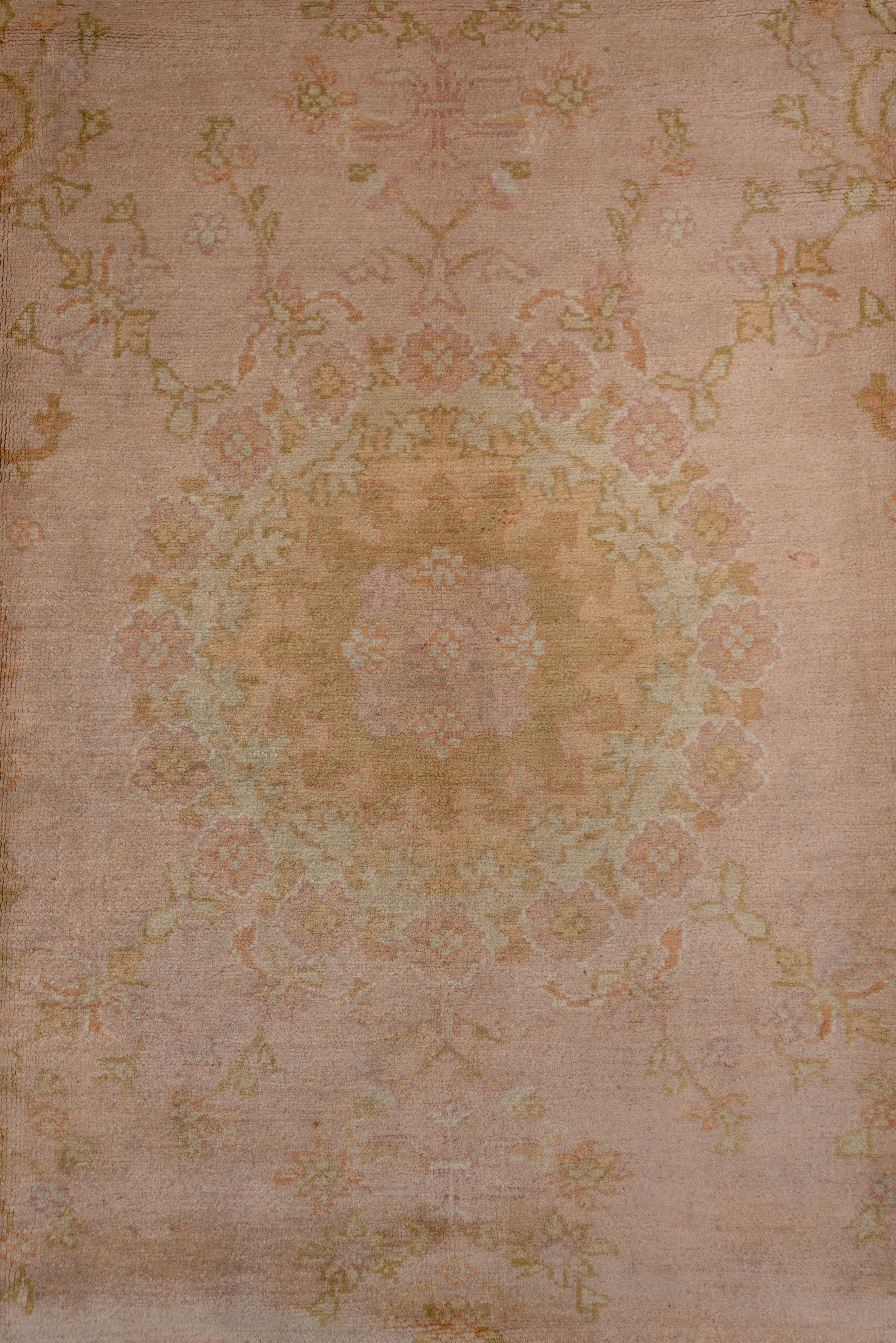 Early 20th Century 1920s Antique Pink Oushak Carpet with a Curvilinear Medallion For Sale