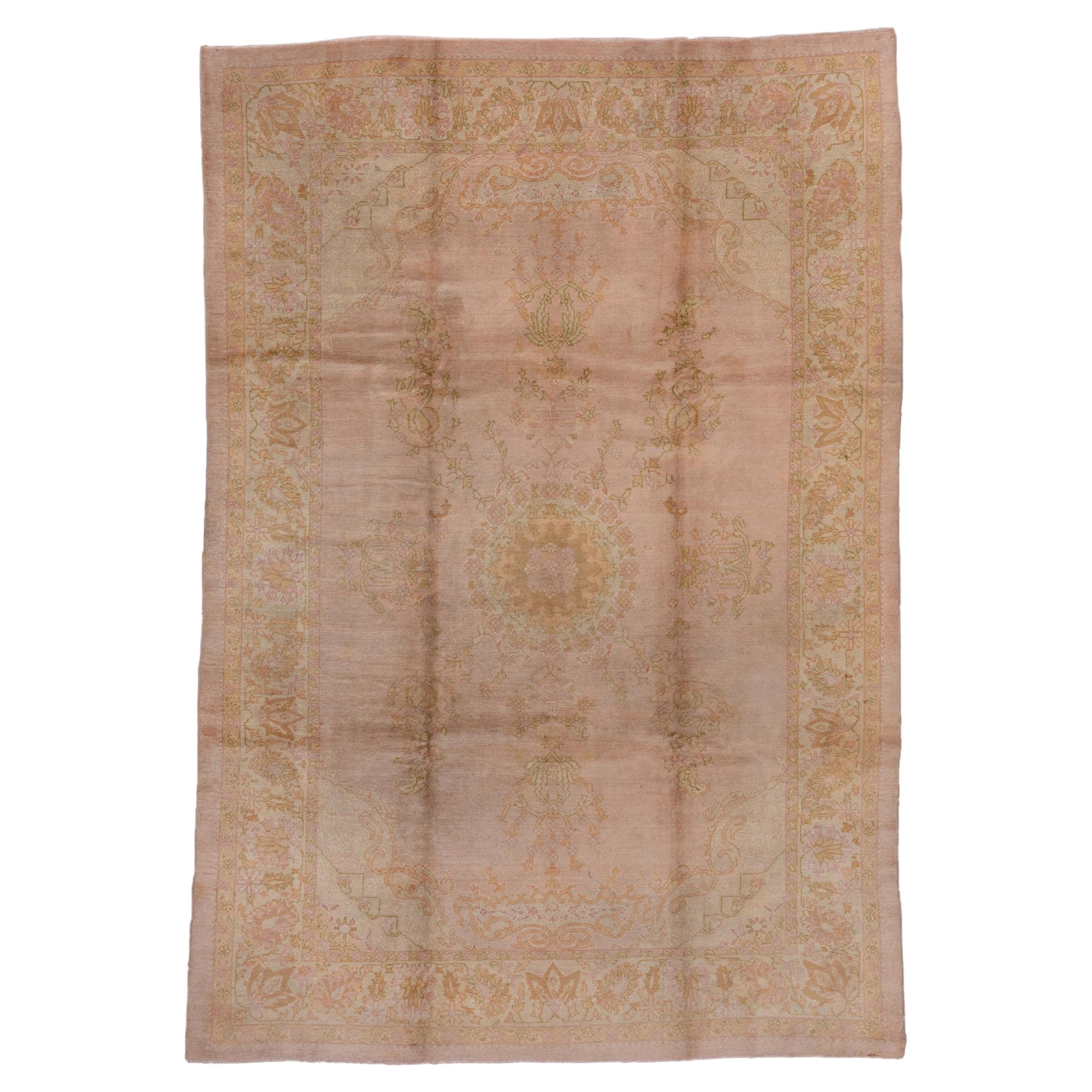 1920s Antique Pink Oushak Carpet with a Curvilinear Medallion For Sale