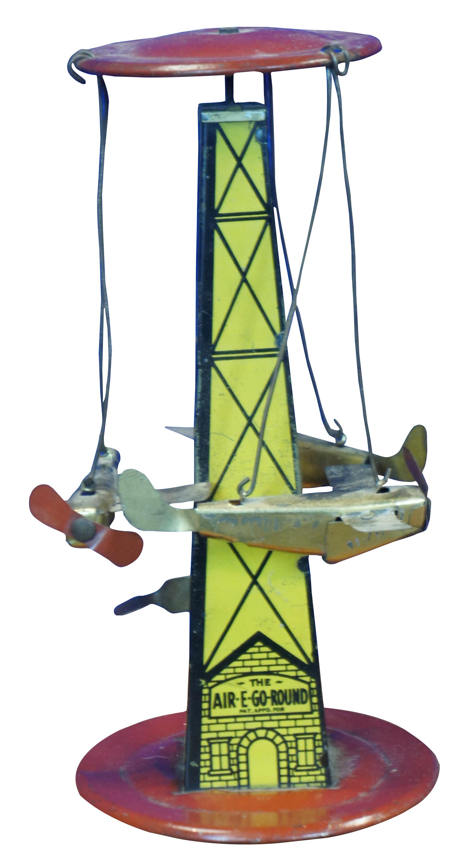 1920’s Air-E-Go-Round tin litho mery-go-round style toy by Reeves Manufacturing Company, featuring a yeloow tower with red cap and base, with three airplanes the circle around it when the lever at the base is pressed.

Reeves Manufacturing Co.