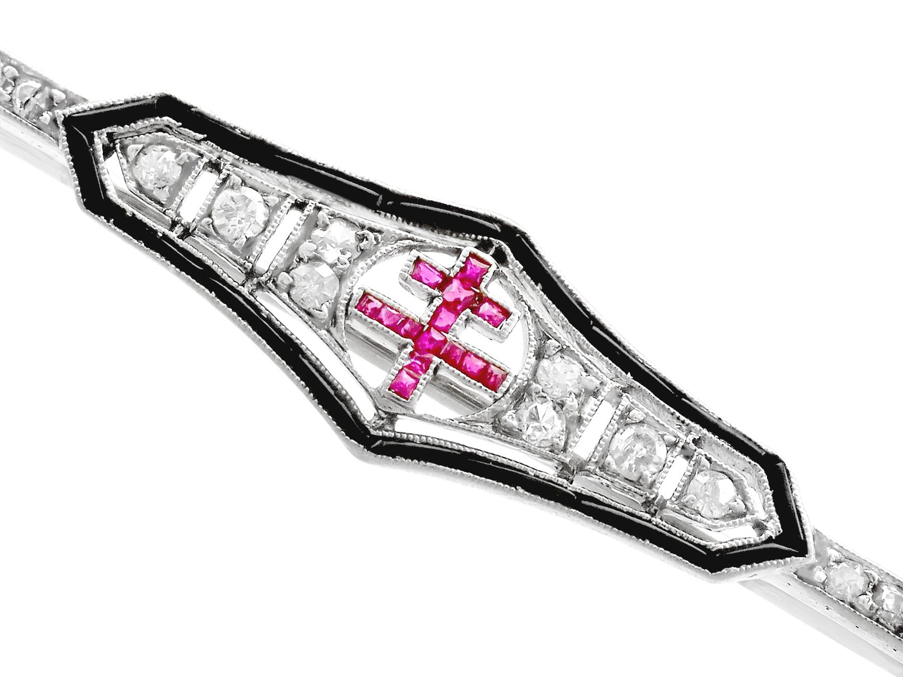 An impressive antique 0.15 carat ruby and 0.96 carat diamond, black onyx and 18 karat white gold bar brooch; part of our diverse antique jewelry and estate jewelry collections.

This fine and impressive antique bar brooch has been crafted in 18k
