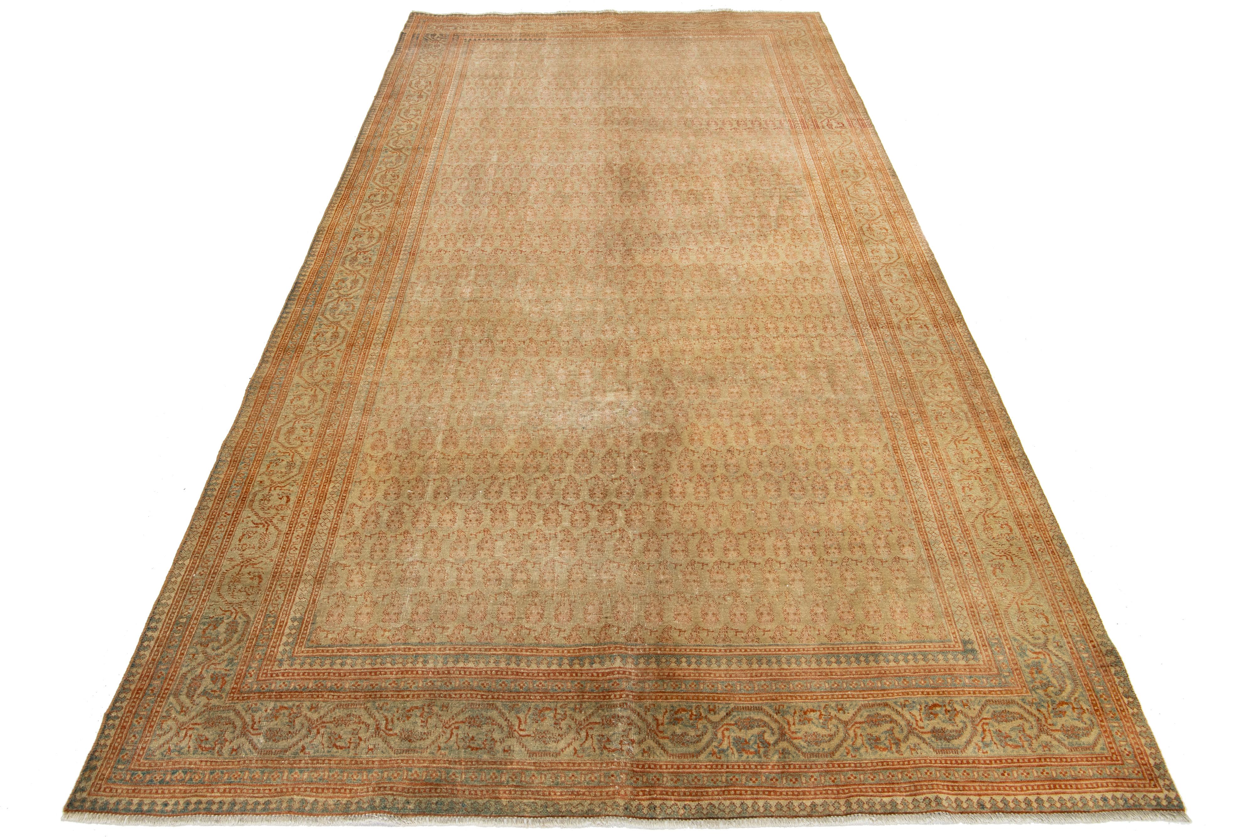 This is a Beautiful Sivas hand-knotted wool rug with a beige-tan field. It has a designed frame and accents in a gorgeous classic boteh pattern. 

This rug measures 5'5