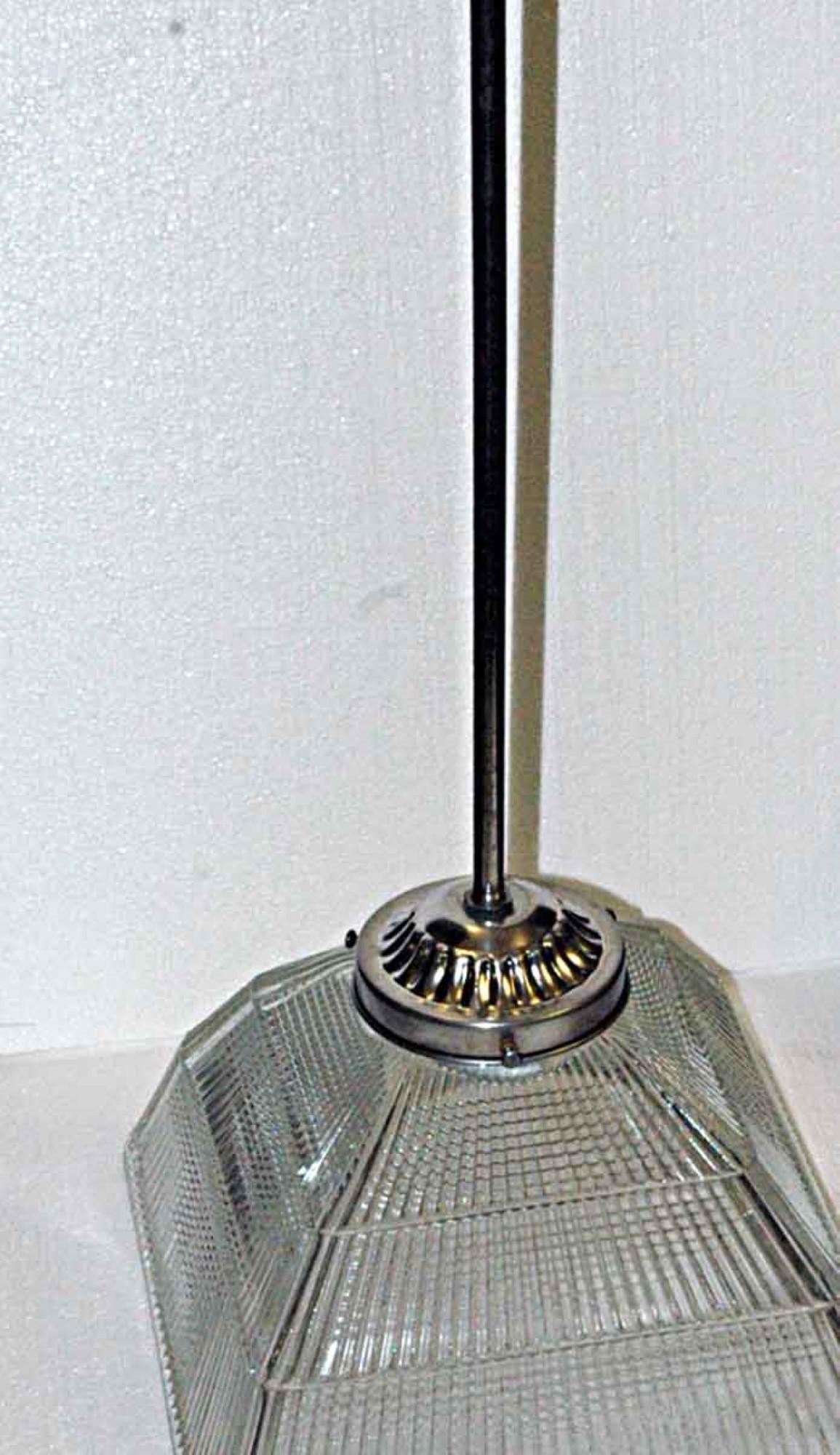 These are original antique industrial lights from 1920. The glass is original Holophane patented prism glass. Price includes restoration. Hardware is new. Please specify the overall drop that is needed upon purchasing. Available in antique brass and
