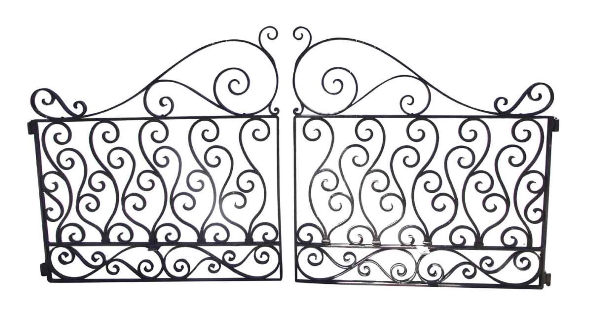 1920s curled swirly detailed two-piece wrought iron driveway gates with a natural black finish. Priced as a pair. This can be seen at our 1800 South Grand Ave location in Downtown LA.