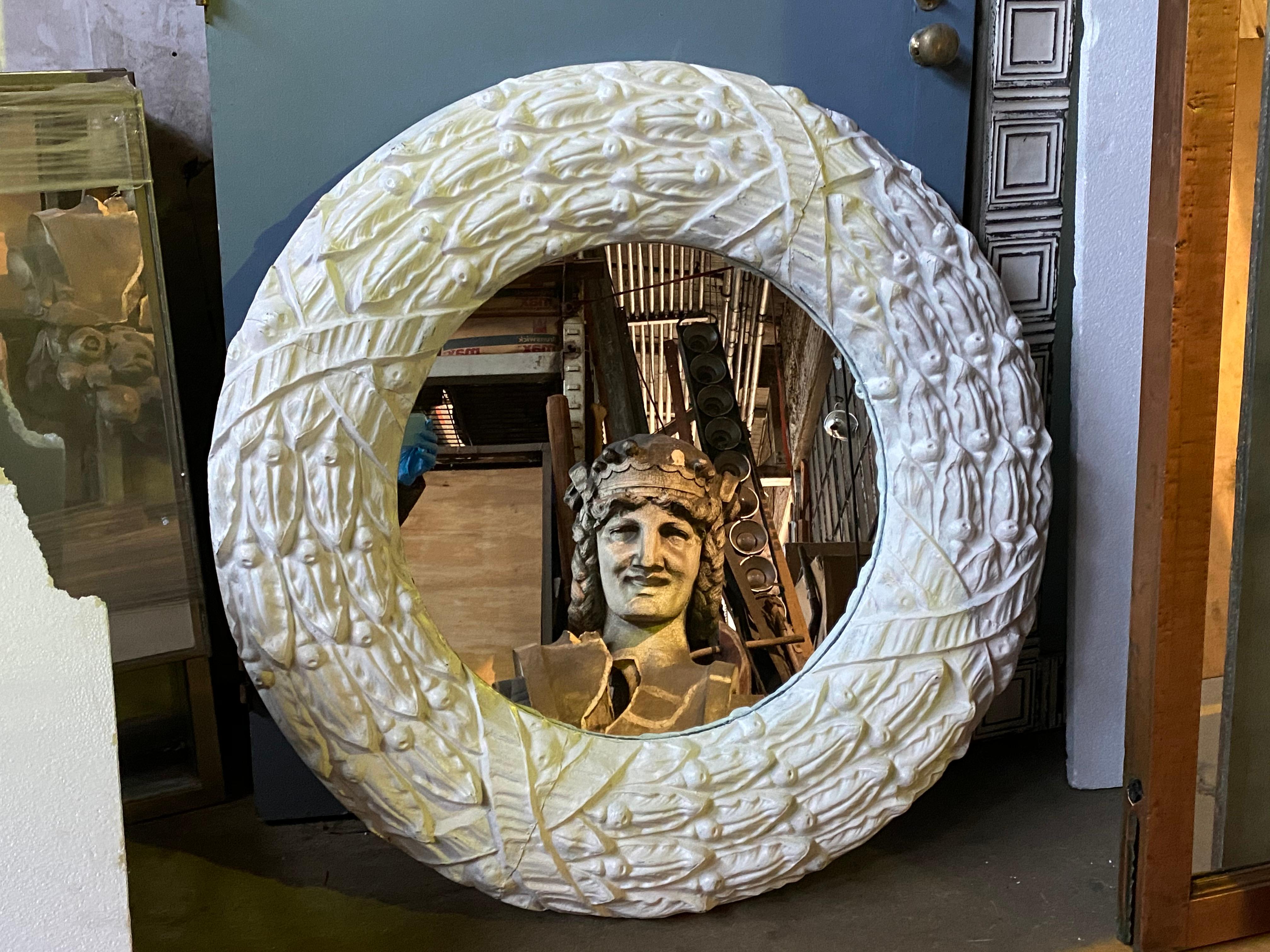 1920s antique zinc window surround newly crafted into a large round mirror with a white finish. This can be seen at our 400 Gilligan St location in Scranton. PA.