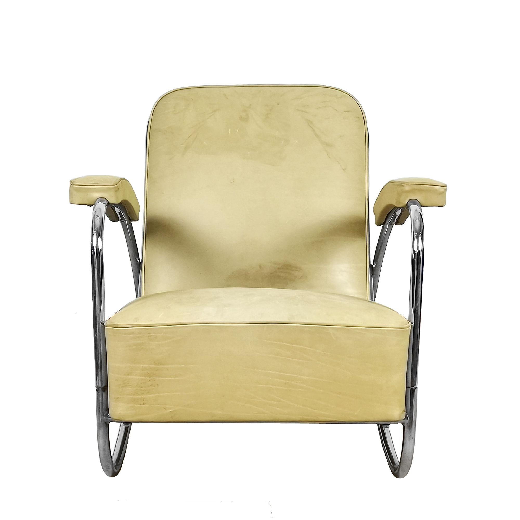 Armchair, chrome plated tubular structure with wooden frames for seat and back. 