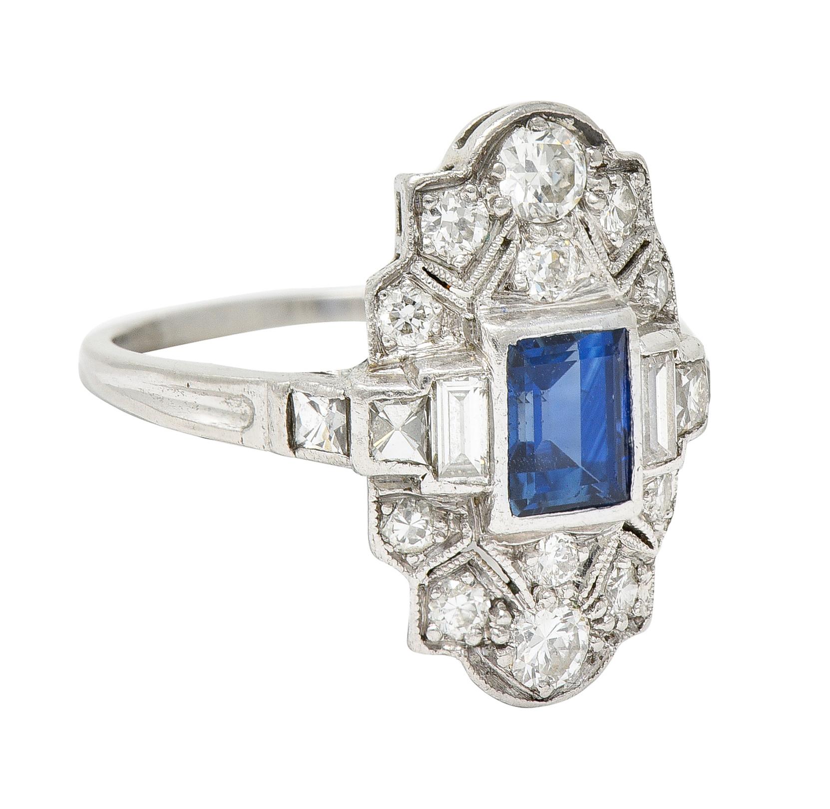 Dinner ring features a bezel set rectangular cut sapphire

Weighing approximately 0.95 carat with vivid and uniform royal blue color

Flanked by tiered shoulders - flushly set with French and baguette cut diamonds

Accompanied by stylized geometric