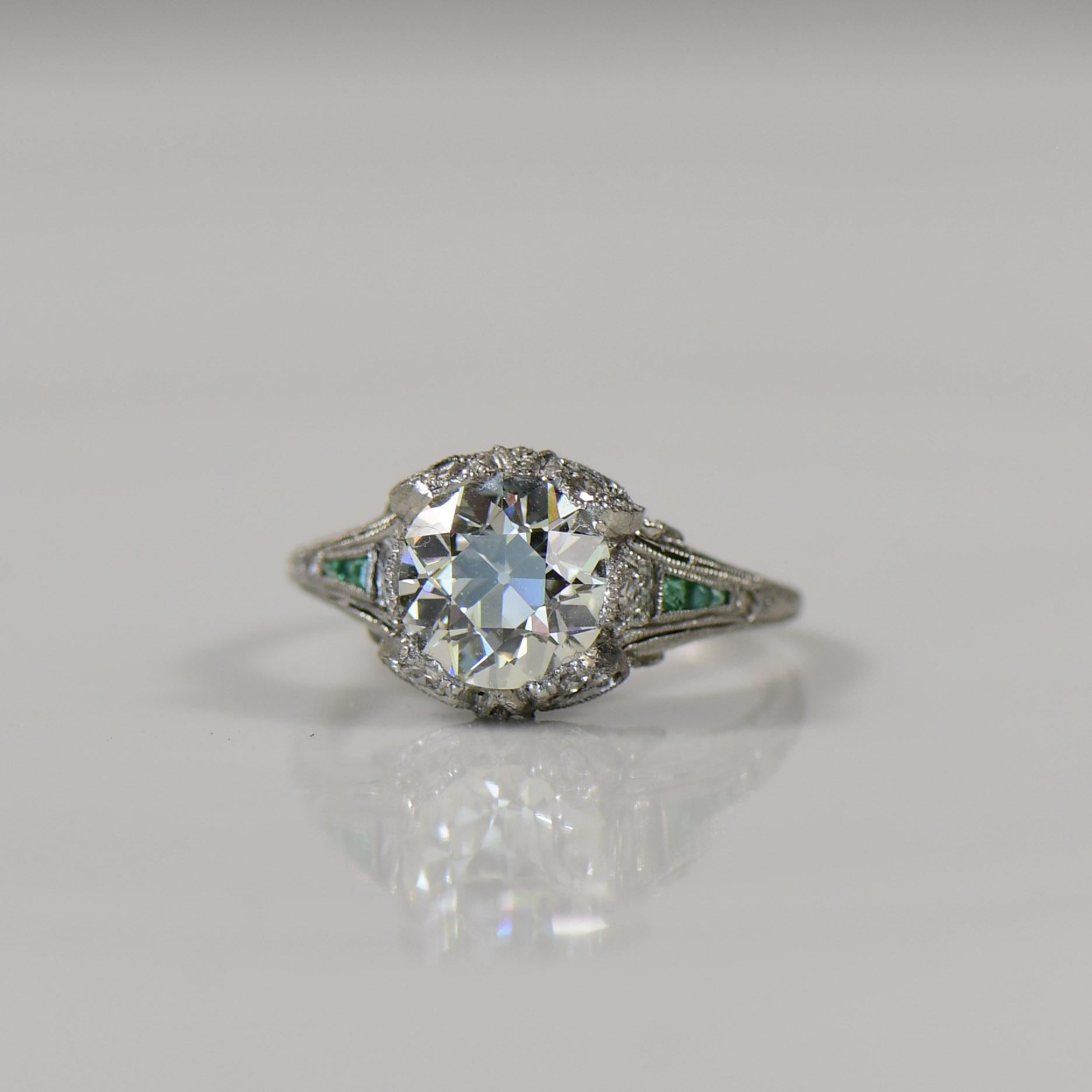 This exquisite early Art Deco ring from the 1920s features a striking platinum bow motif, capturing the essence of the era's glamour and geometric design. The centerpiece showcases a radiant old euro cut, drawing attention with its timeless