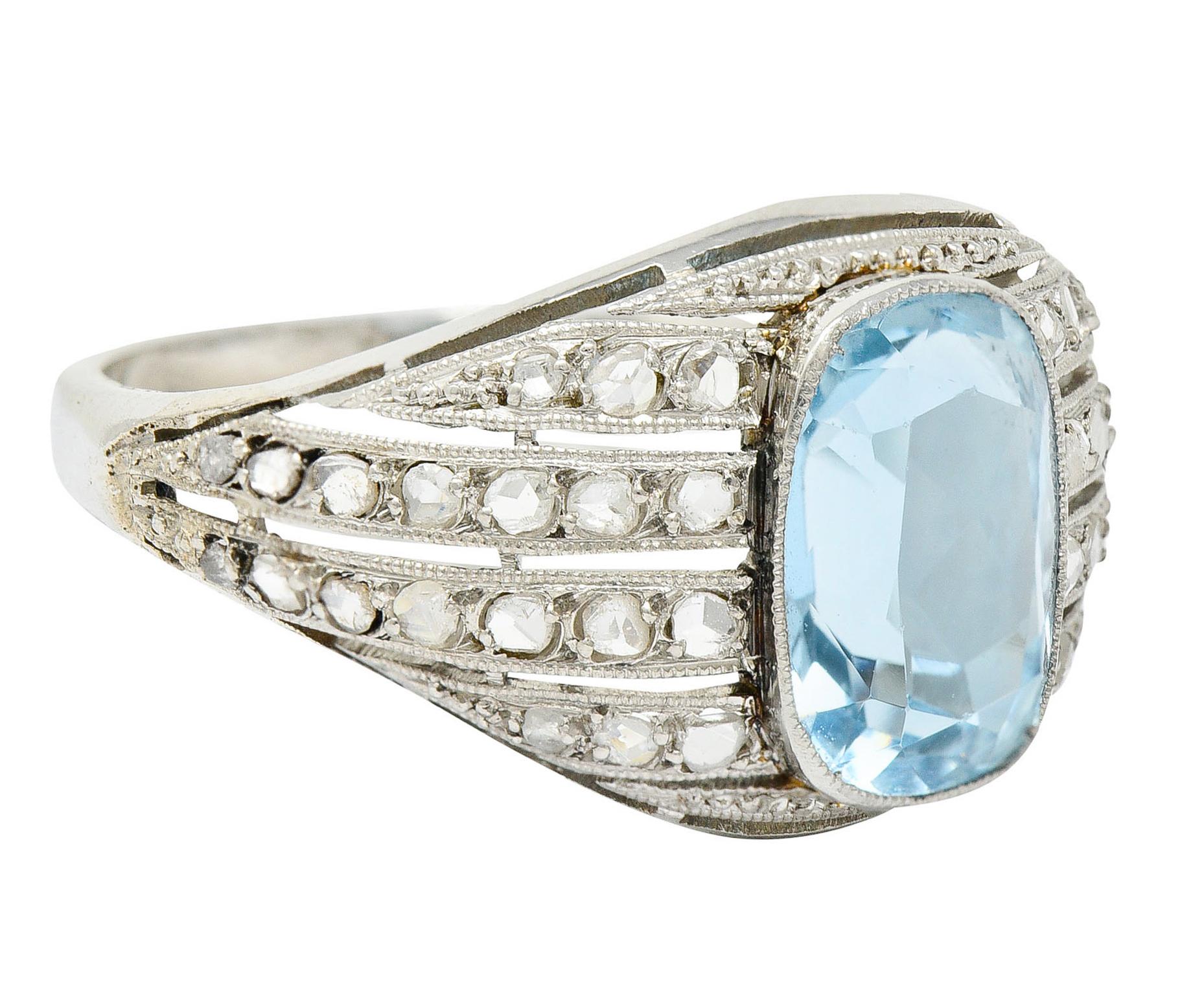 Bombè band ring centers a rectangular cushion cut aquamarine weighing approximately 1.95 carats

Bezel set, transparent, and light sky blue in color

Flanked by rows of rose cut diamonds weighing in total approximately 0.60 carat

Accented